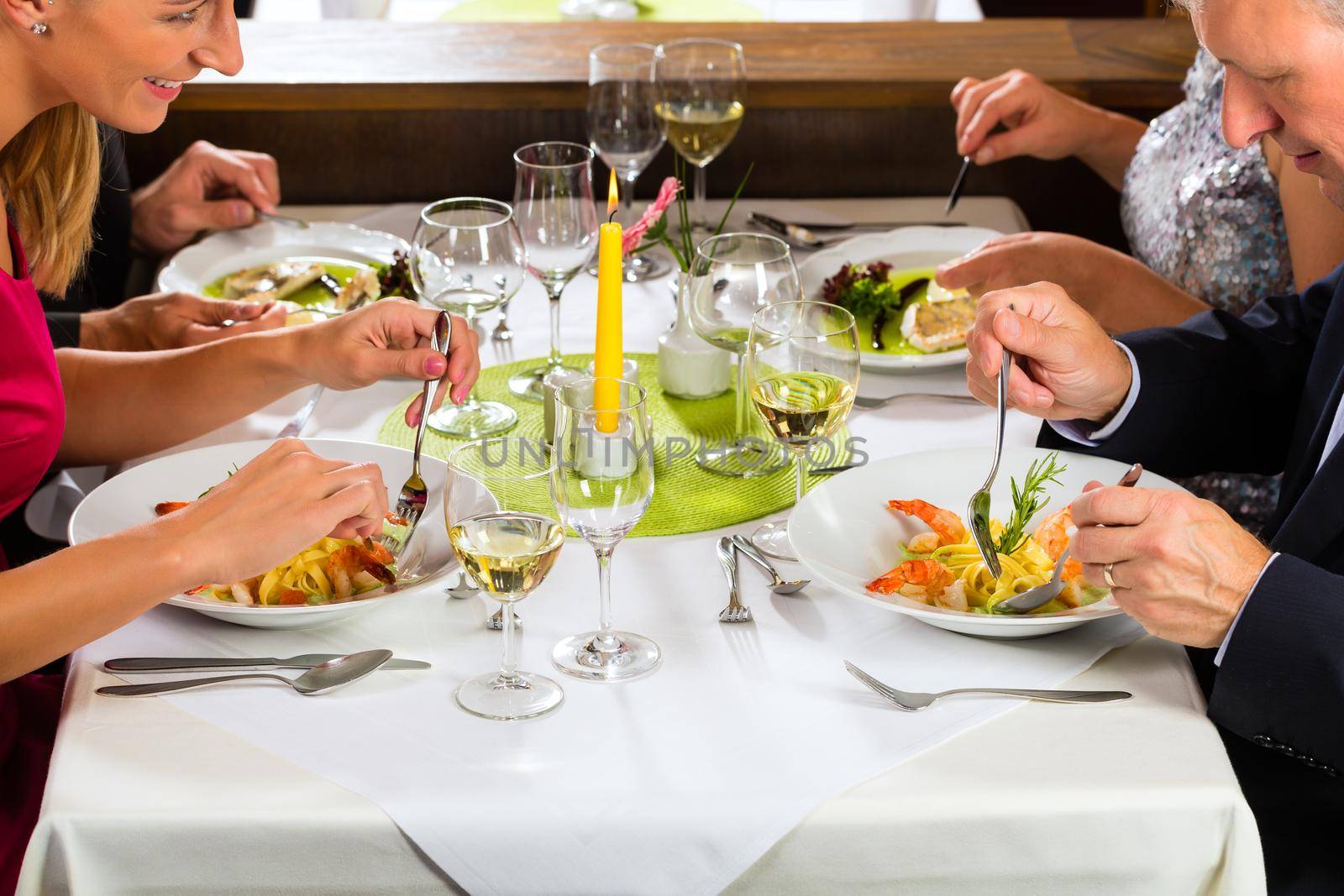 Family, mother and father with adult children and daughter or son in law –fine dining in nice restaurant or hotel