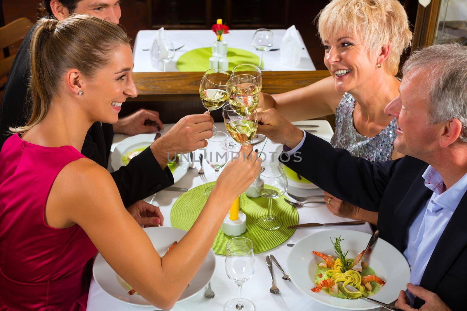 Family, mother and father with adult children and daughter or son in law –fine dining in nice restaurant or hotel