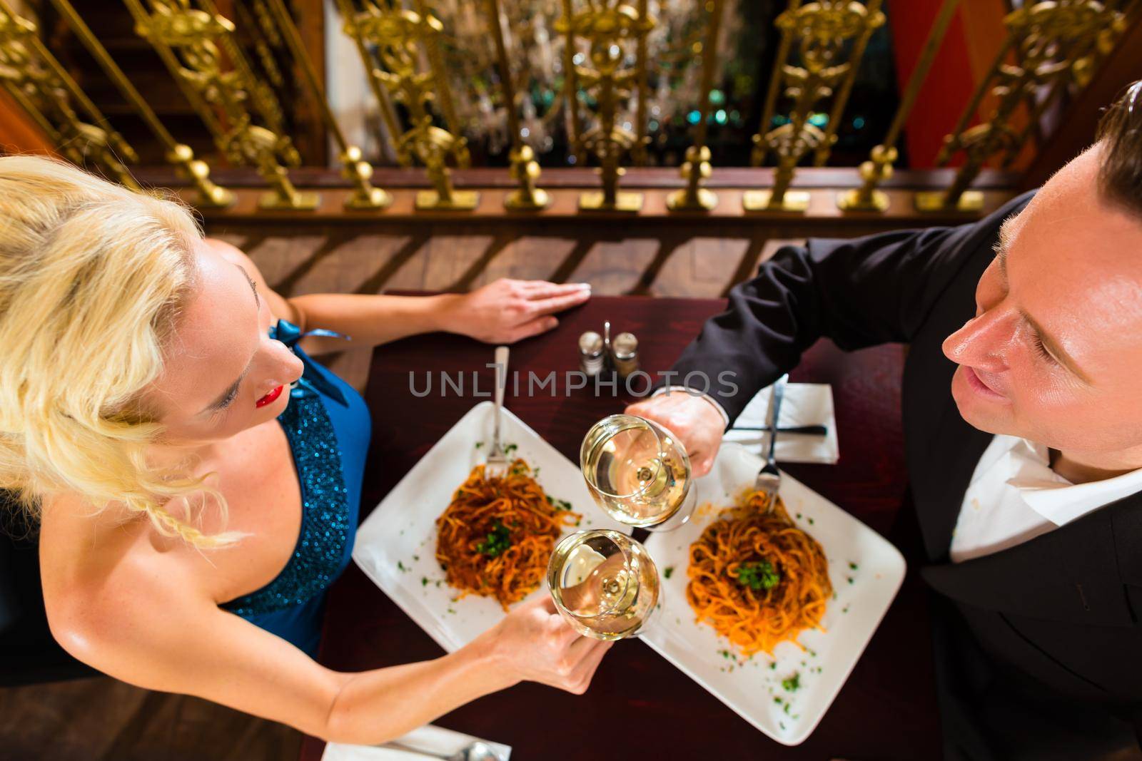happy couple have a romantic date in restaurant by Kzenon