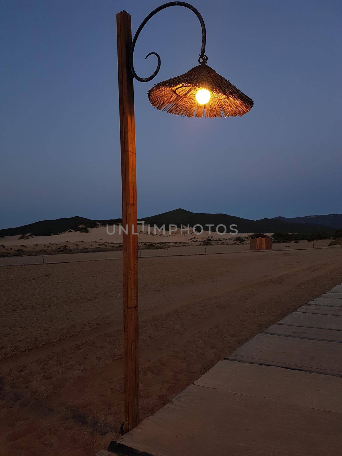 a lamp post on the beach avenue during a summer evening