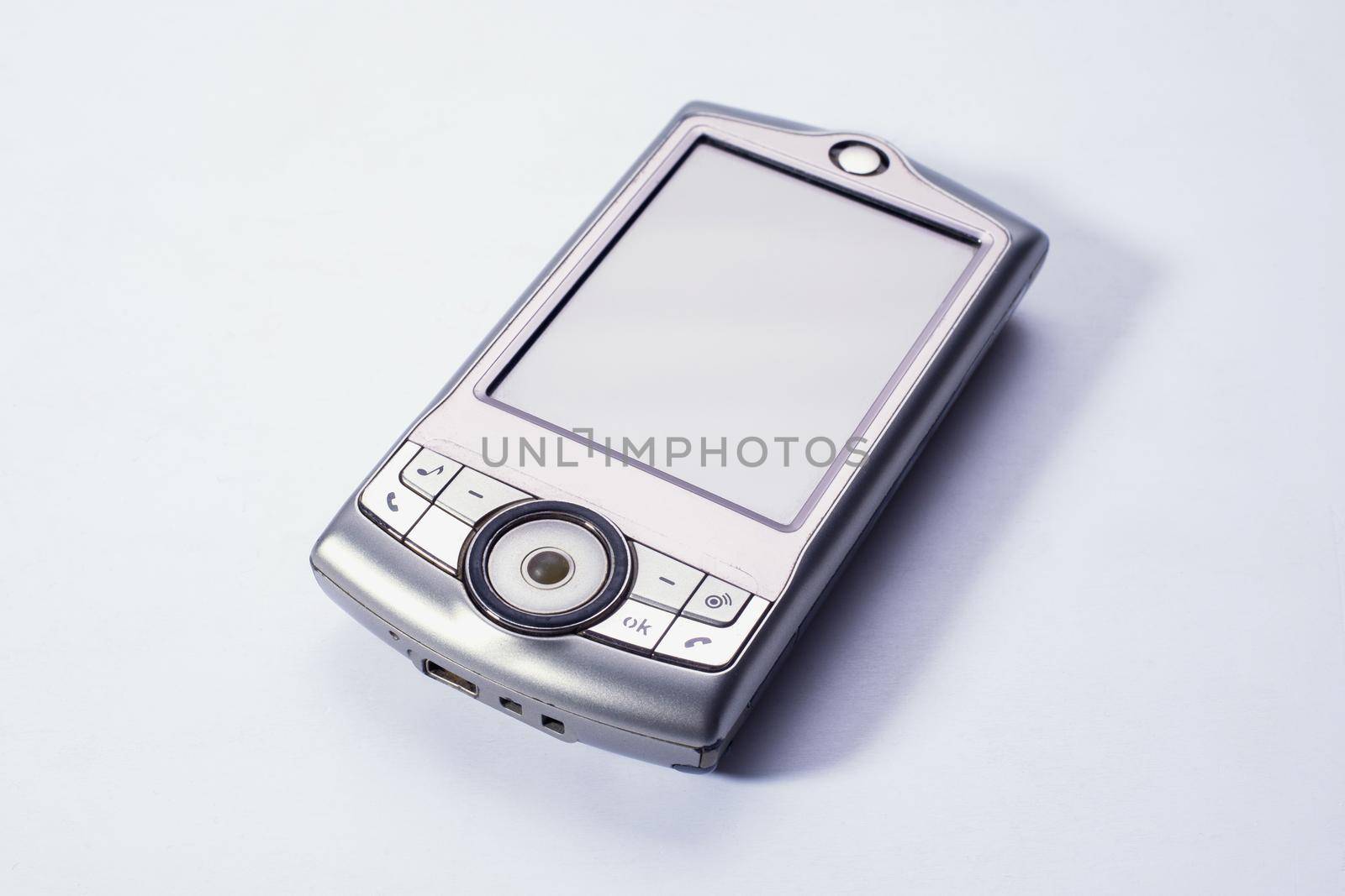 The old mobile phone is out of date. Touch screen. Light background.