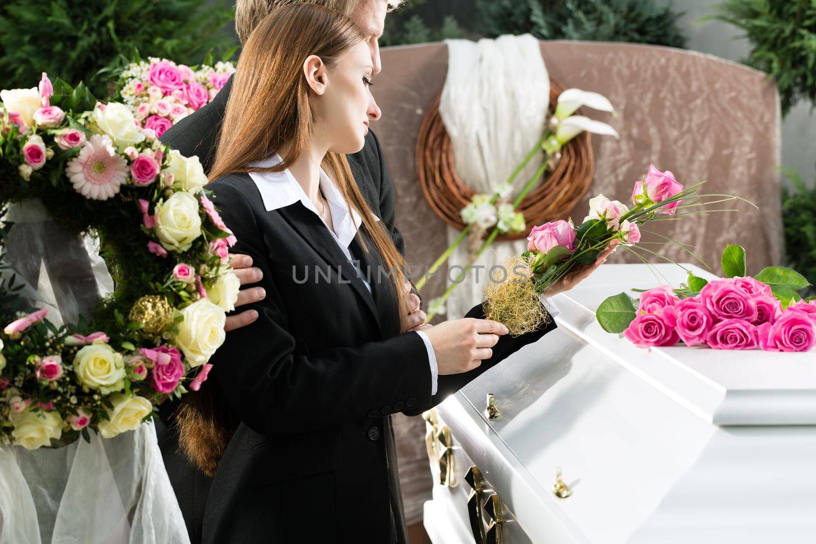 Mourning People at Funeral with coffin by Kzenon