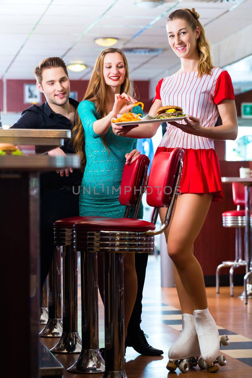 People in American diner or restaurant and waitress by Kzenon