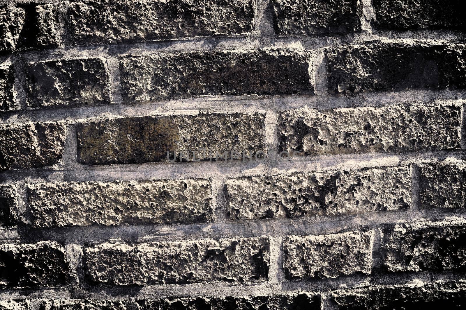 Aged and weathered old brick wall texture in a retro vintage design  by MP_foto71