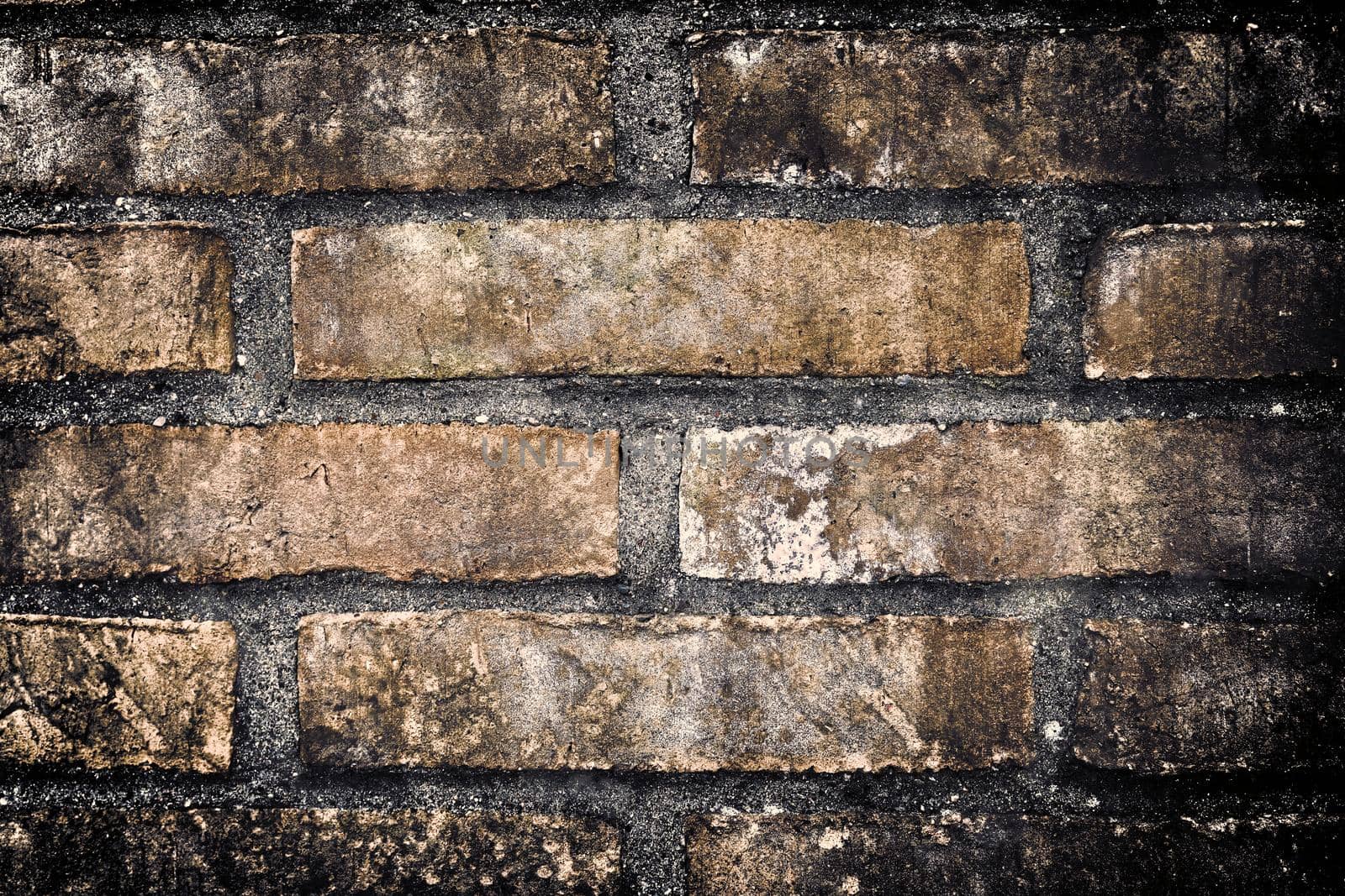 Aged and weathered old brick wall texture in a retro vintage design  by MP_foto71