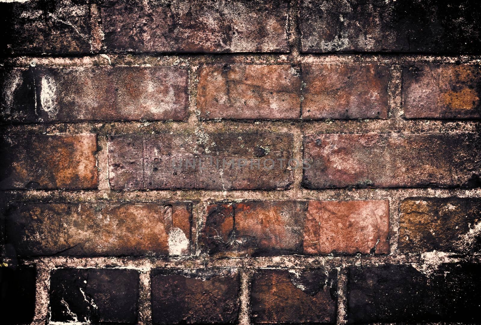 Aged and weathered old brick wall texture in a retro vintage design  by MP_foto71