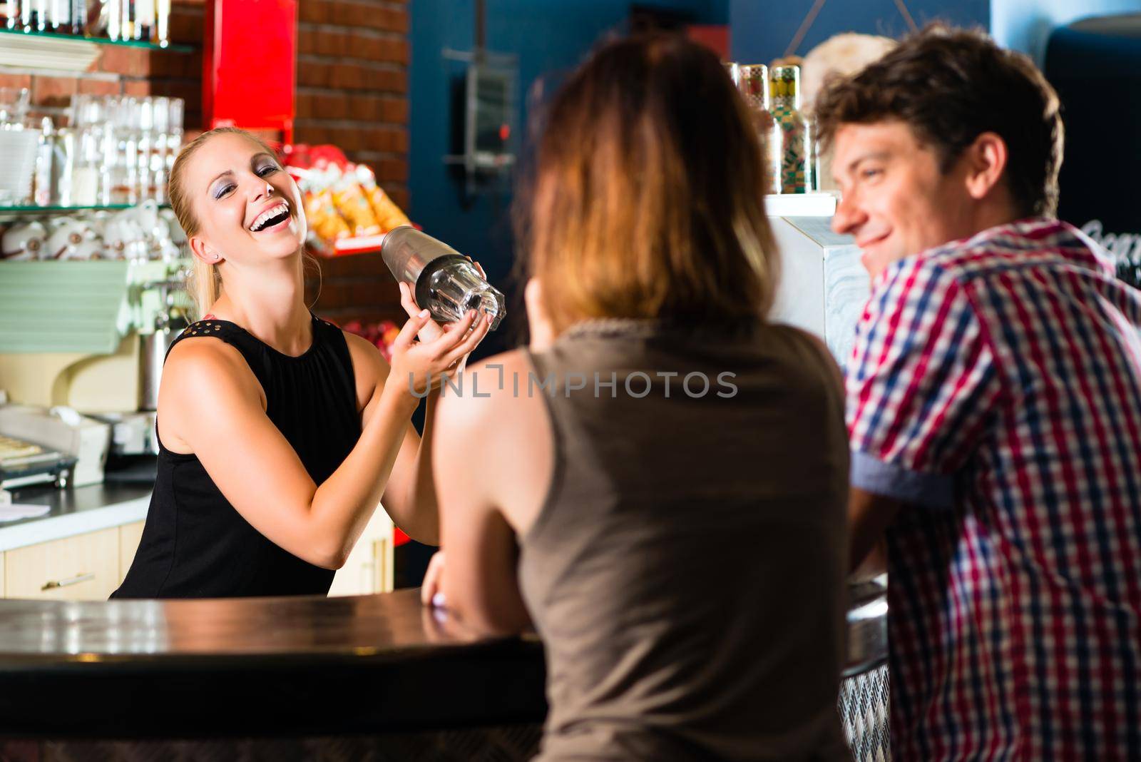 People in club or bar drinking by Kzenon