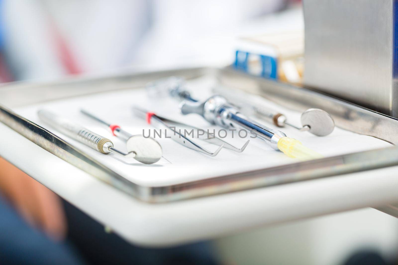 Sterile tools or medical instruments for a dentist, mirrors, tweezers, and syringe for local anesthetic in a dental practice