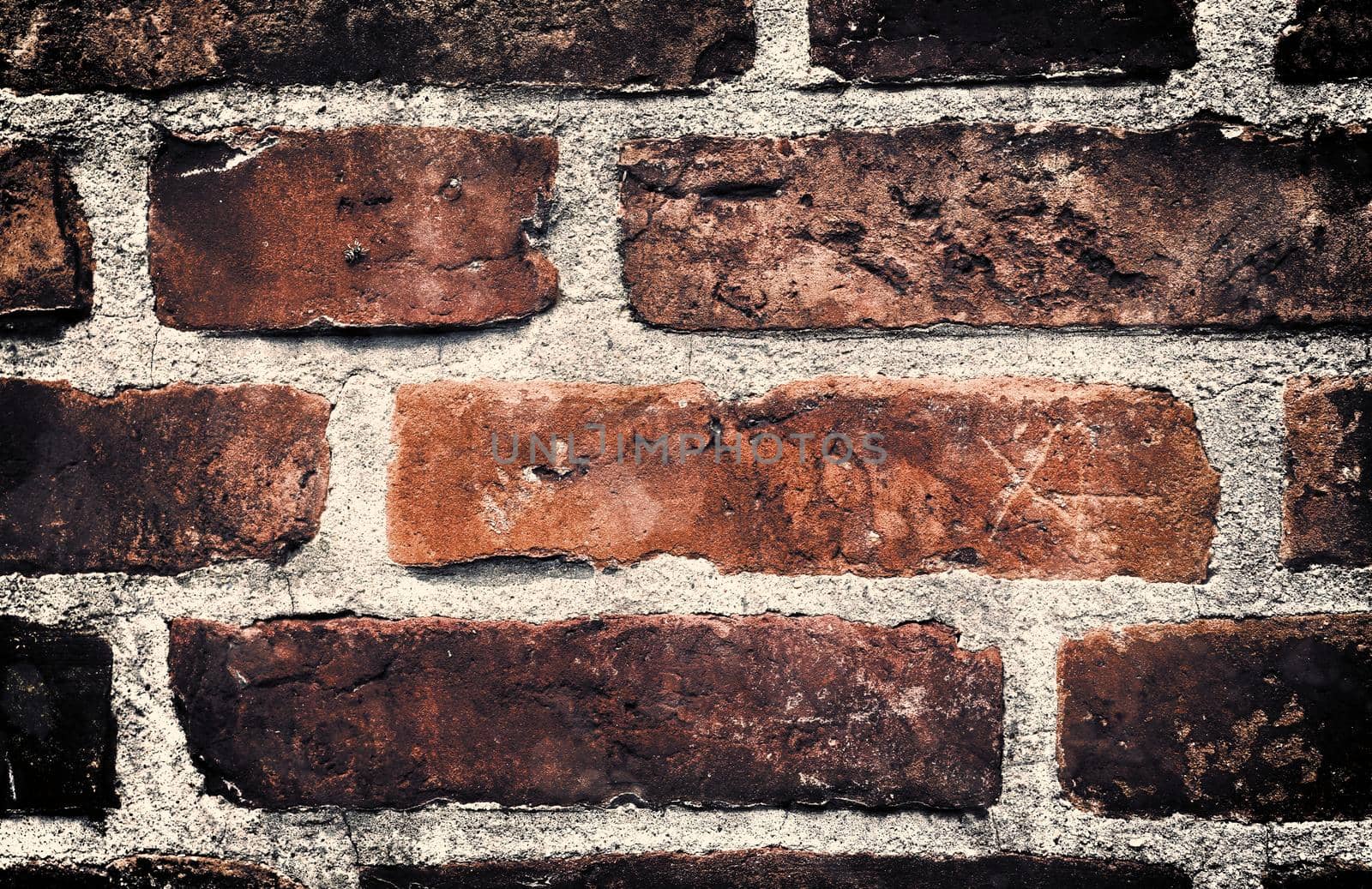 Aged and weathered old brick wall texture in a retro vintage design  by MP_foto71