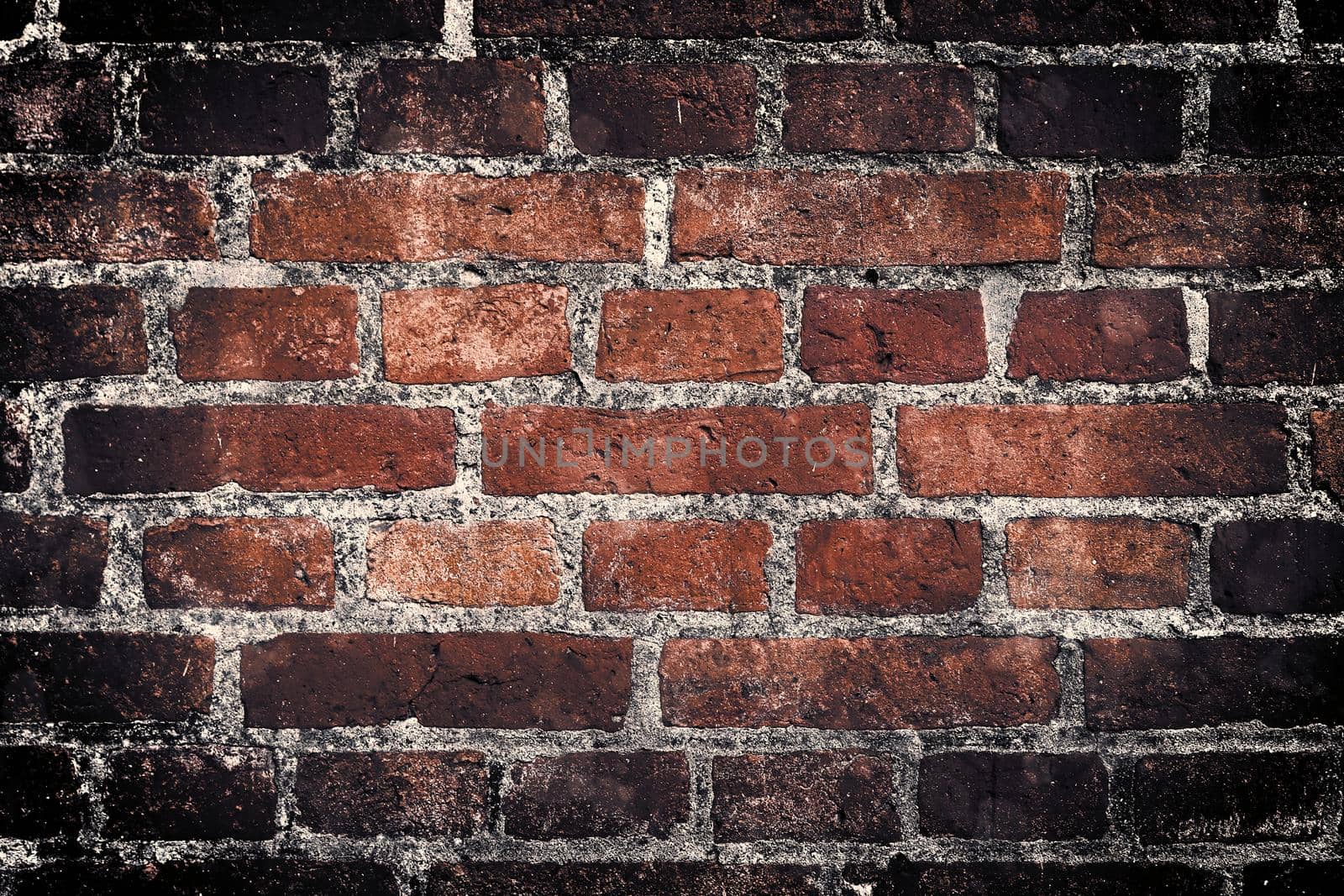 Aged and weathered old brick wall texture in a retro vintage design  by MP_foto71