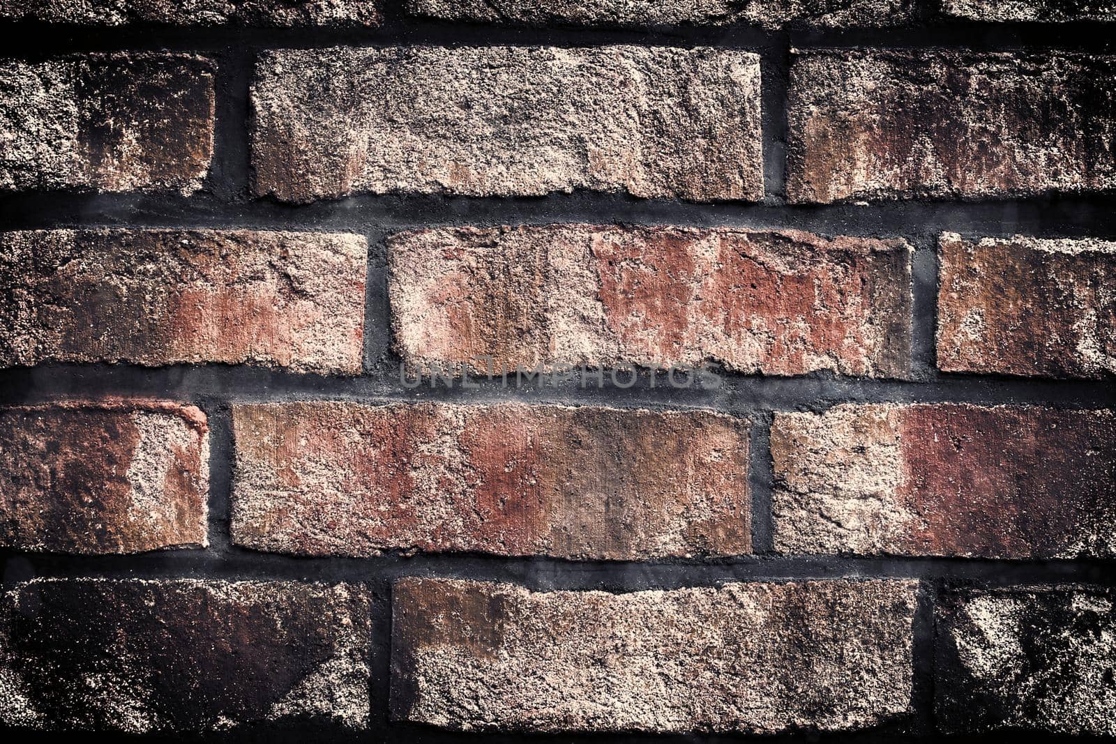 Aged and weathered old brick wall texture in a retro vintage design  by MP_foto71