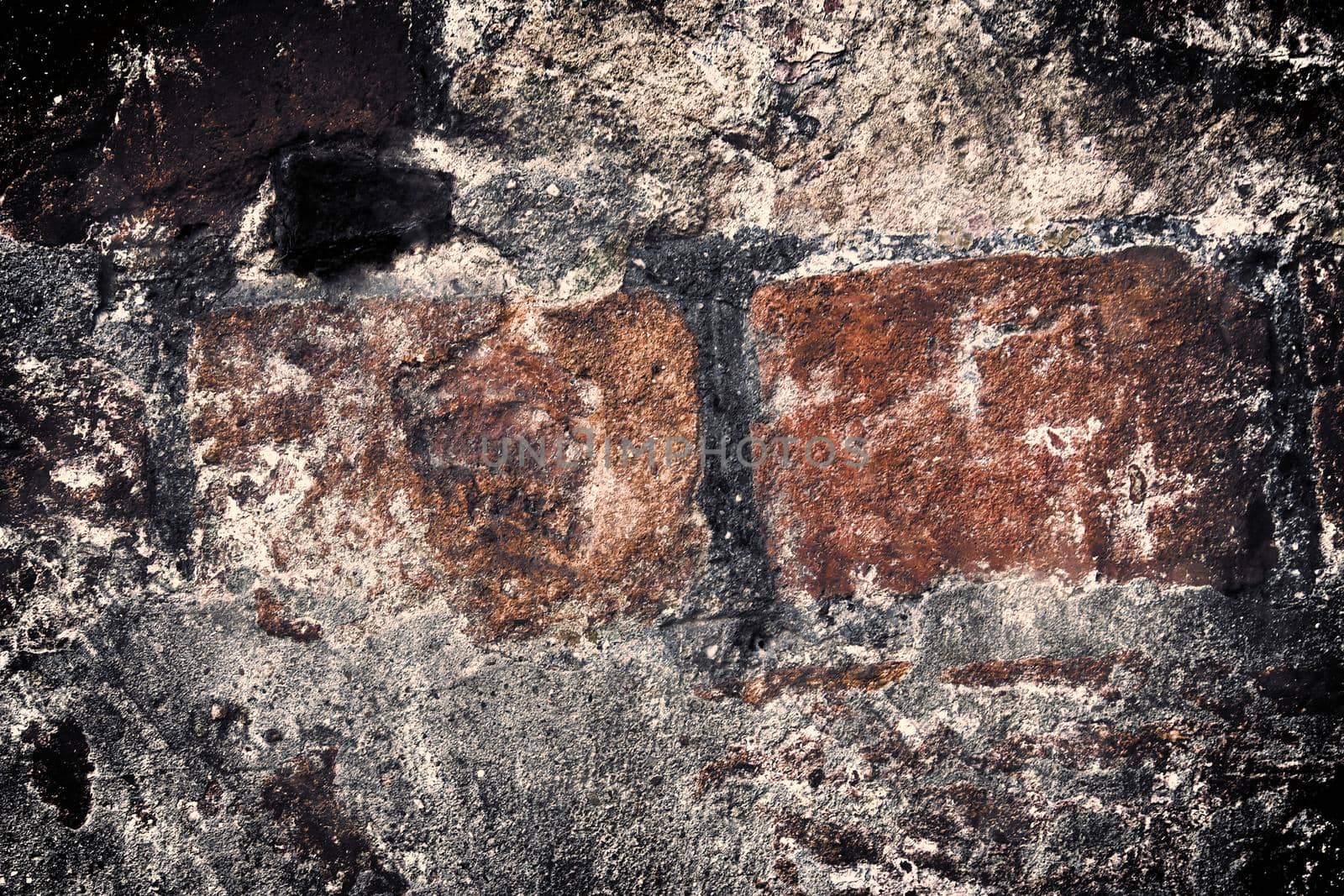 Aged and weathered old brick wall texture in a retro vintage design  by MP_foto71