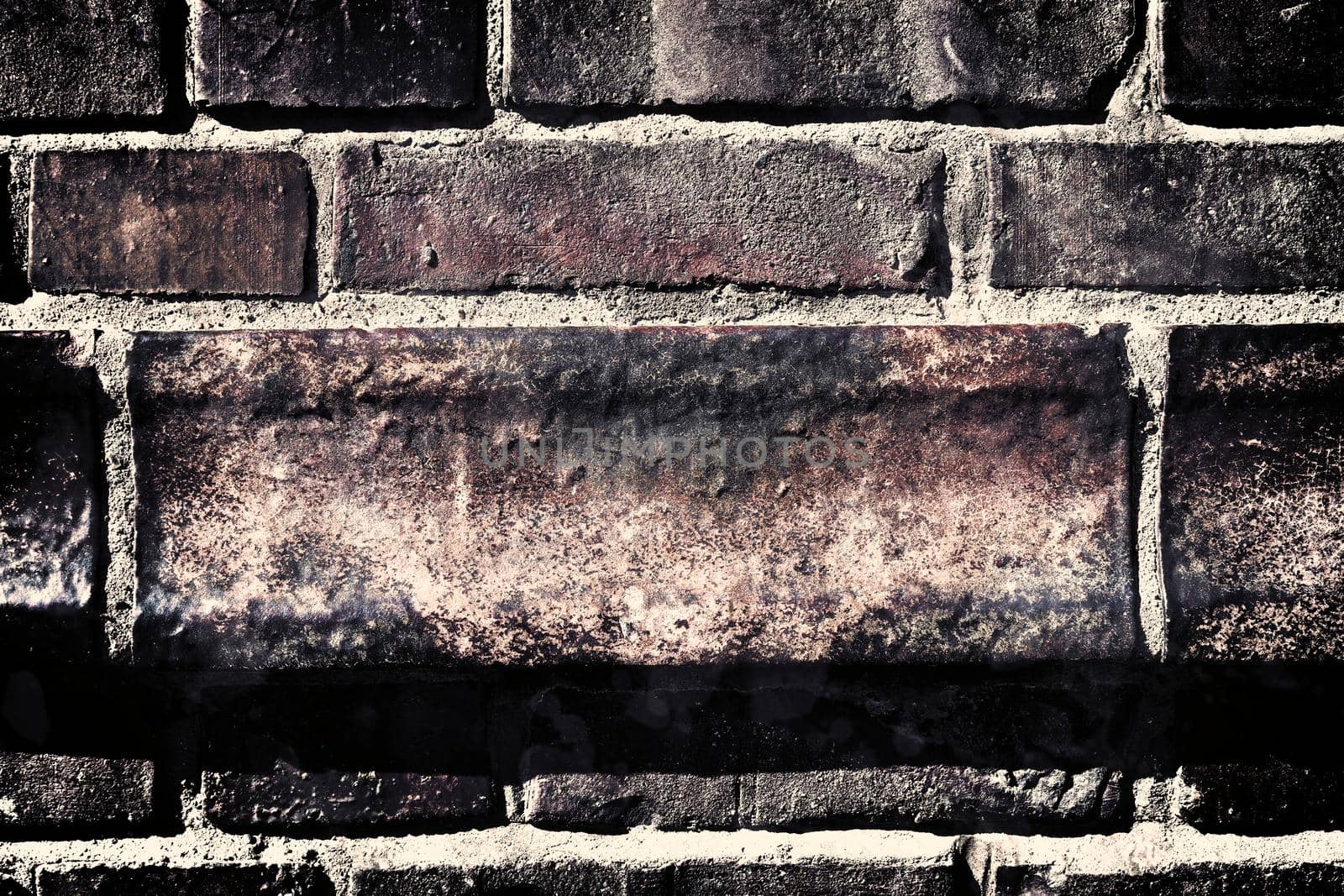 Aged and weathered old brick wall texture in a retro vintage design  by MP_foto71