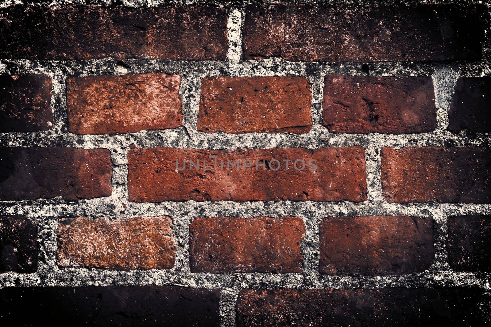 Aged and weathered old brick wall texture in a retro vintage design  by MP_foto71