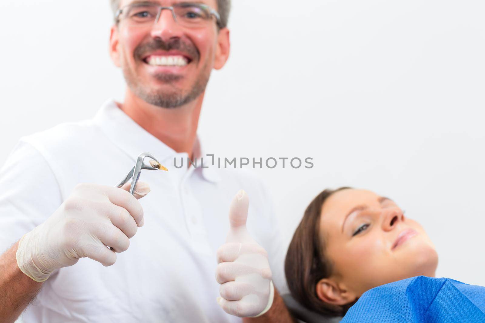 Female patient with dentist in a dental successful treatment