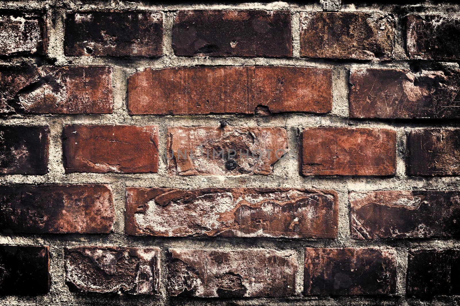 Aged and weathered old brick wall texture in a retro vintage design  by MP_foto71