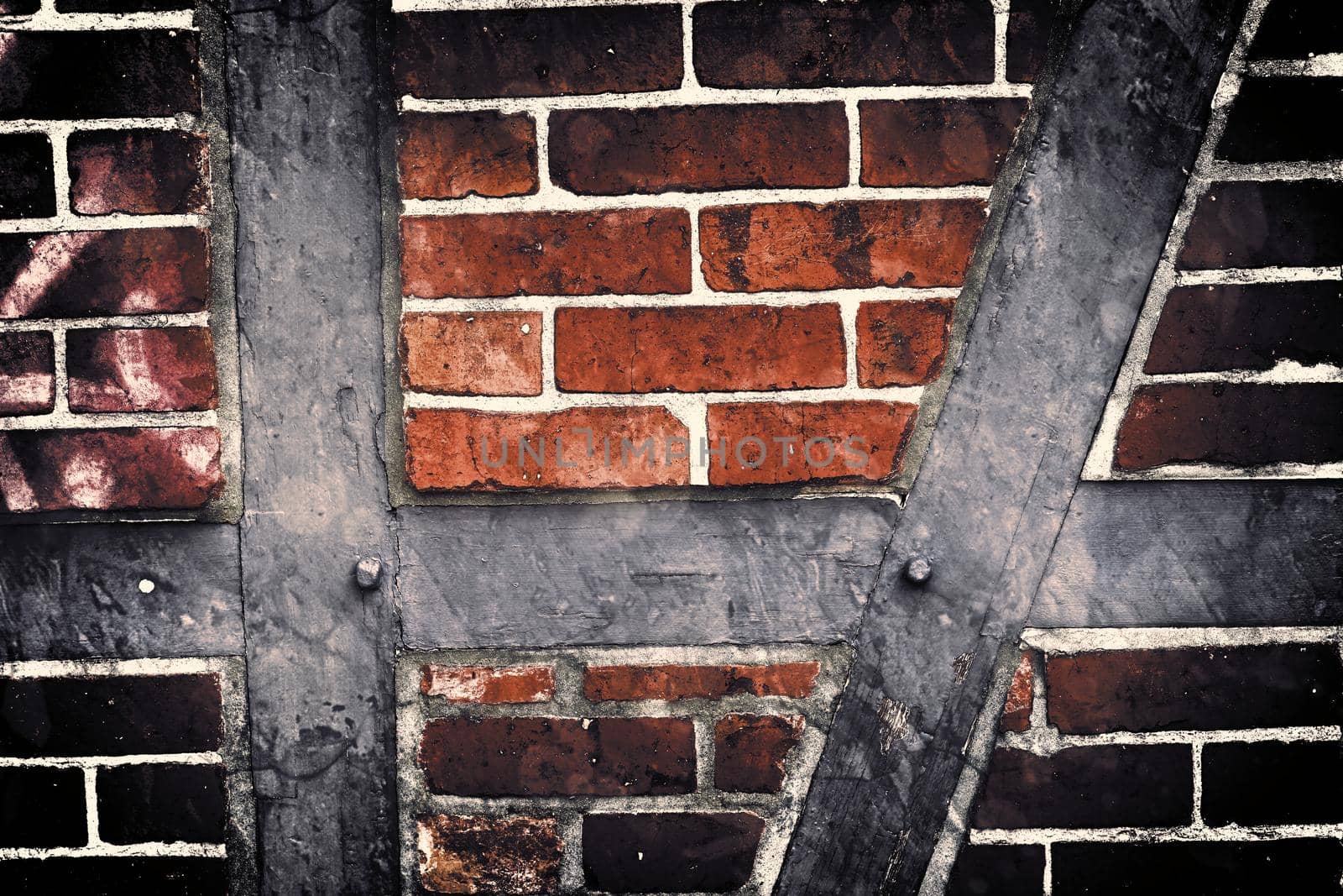 Aged and weathered old brick wall texture in a retro vintage design  by MP_foto71