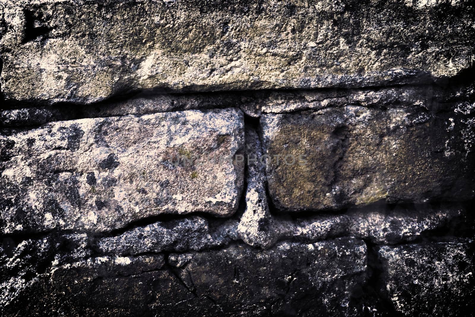 Aged and weathered old brick wall texture in a retro vintage design  by MP_foto71