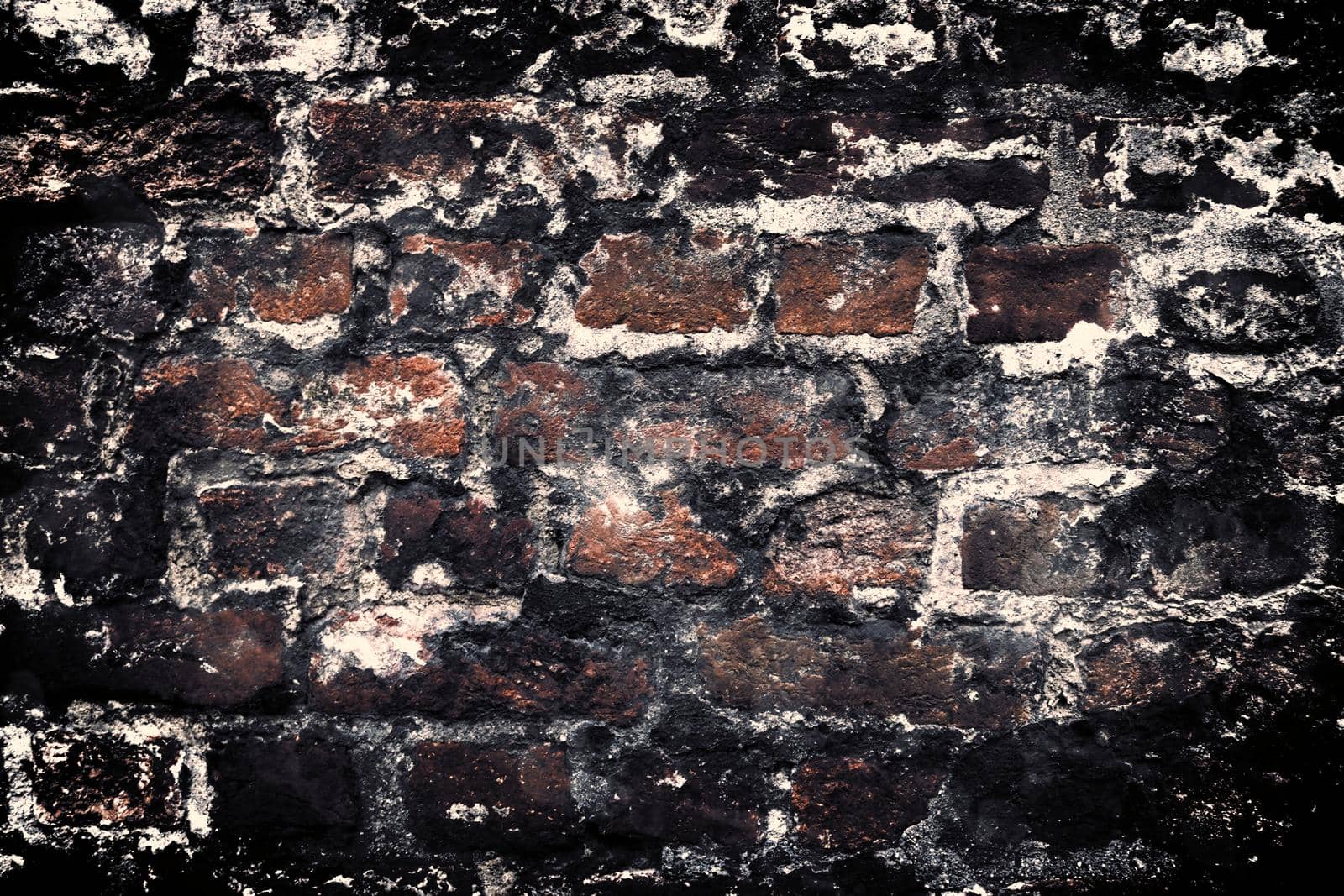 Aged and weathered old brick wall texture in a retro vintage design  by MP_foto71