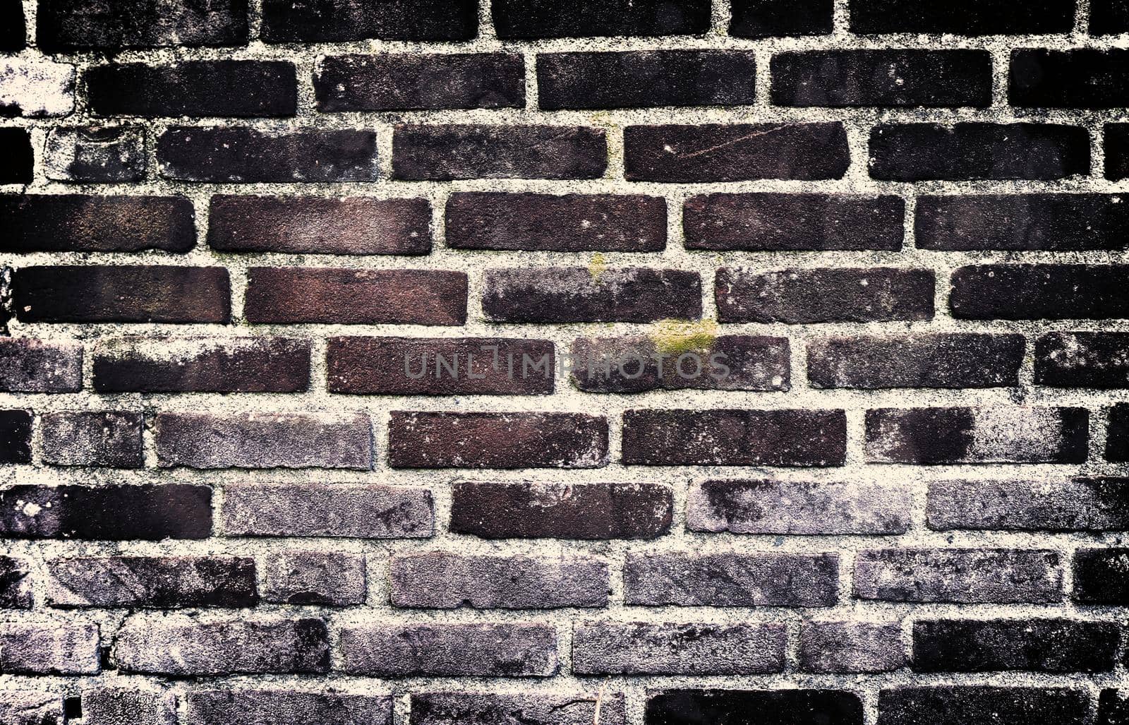 Aged and weathered old brick wall texture in a retro vintage design  by MP_foto71