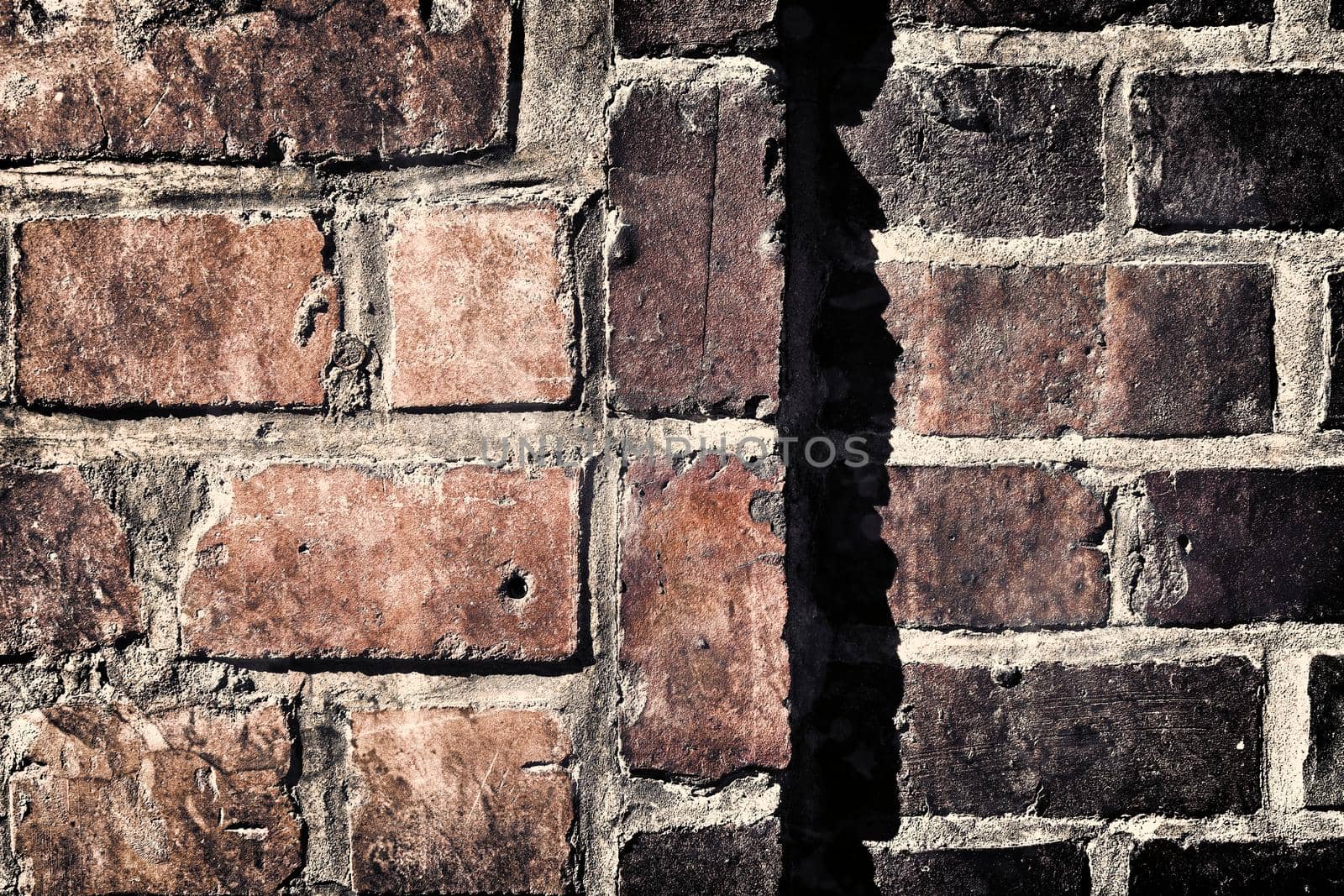 Aged and weathered old brick wall texture in a retro vintage design  by MP_foto71