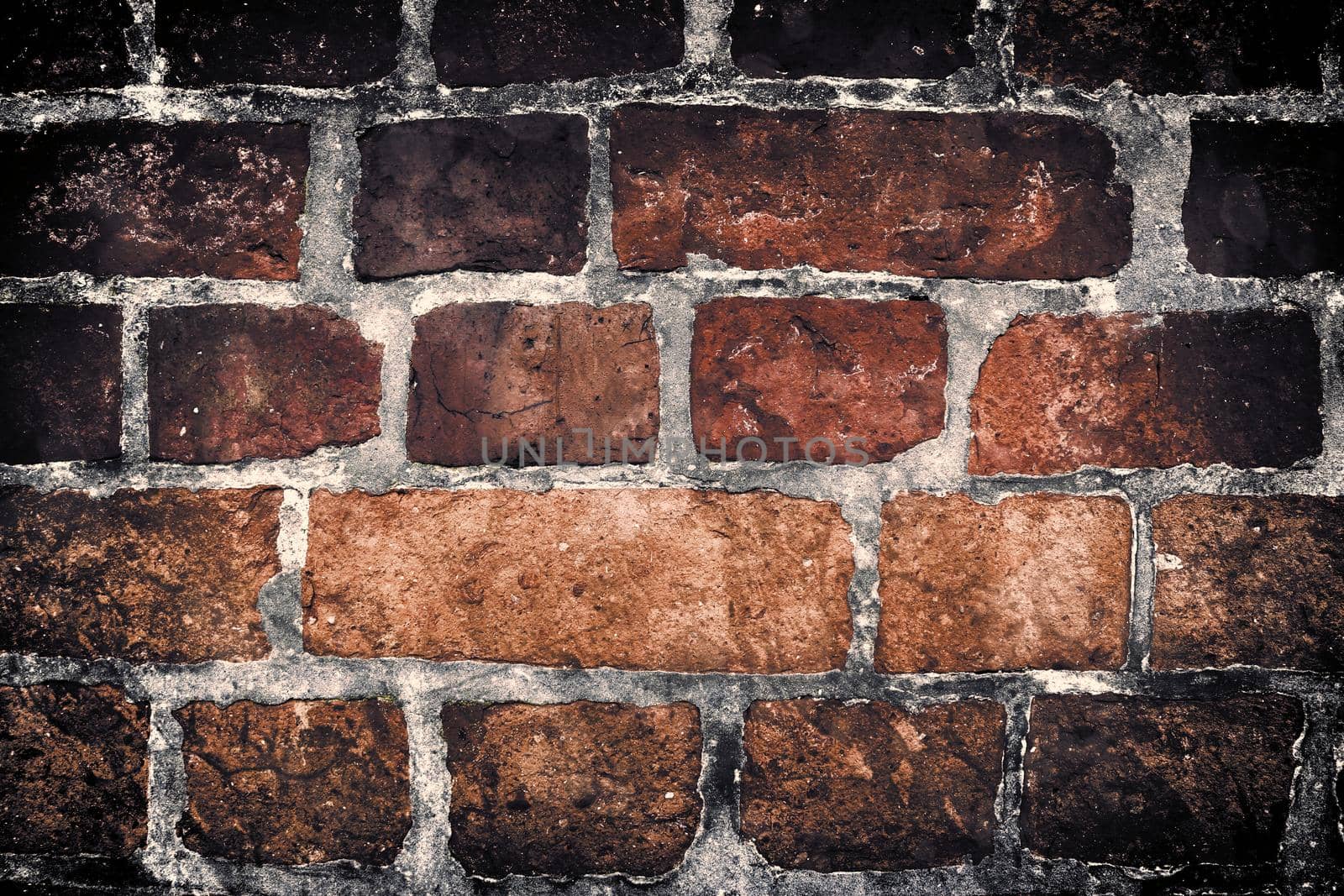 Aged and weathered old brick wall texture in a retro vintage design  by MP_foto71