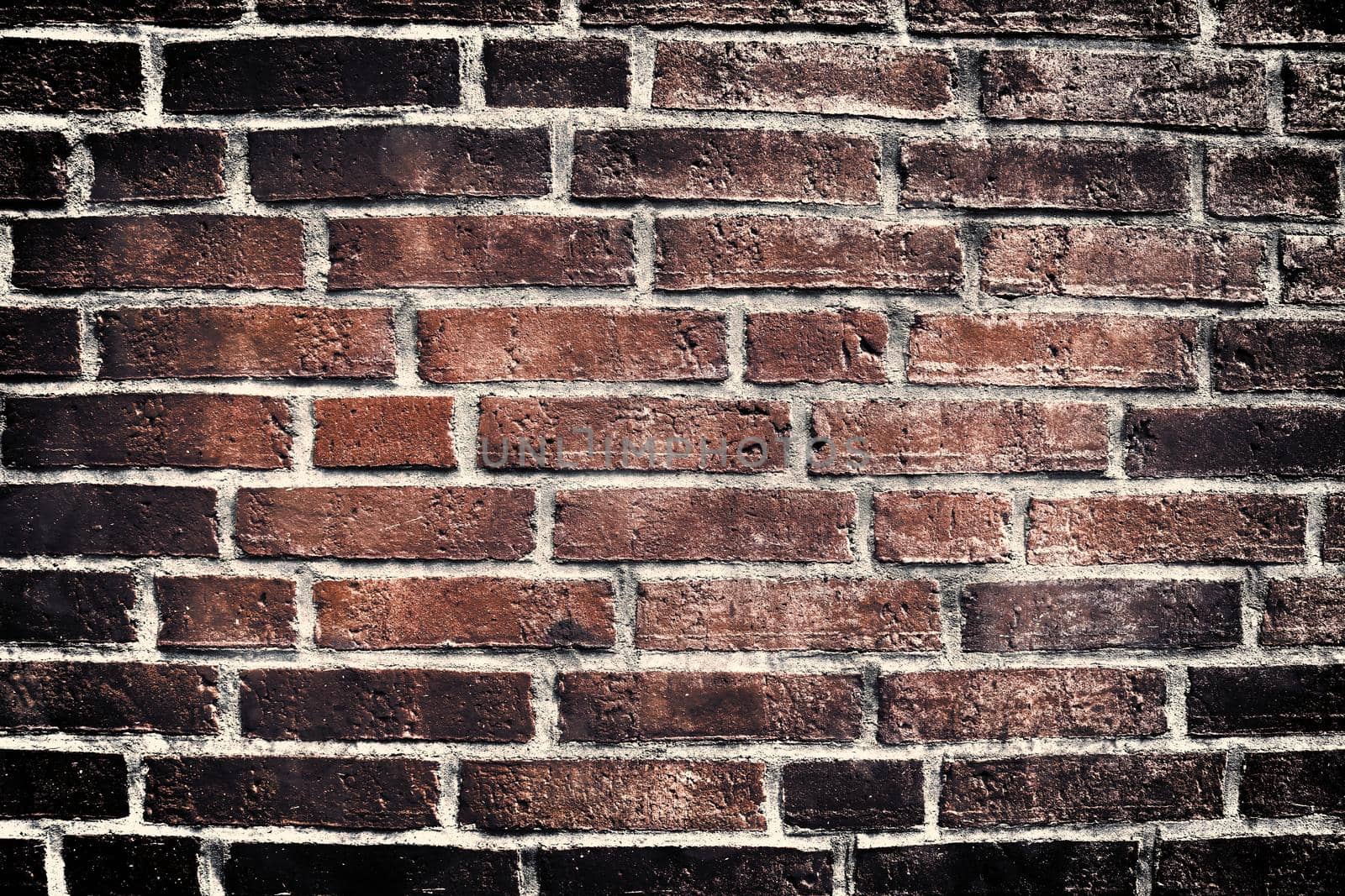 Aged and weathered old brick wall texture in a retro vintage design  by MP_foto71