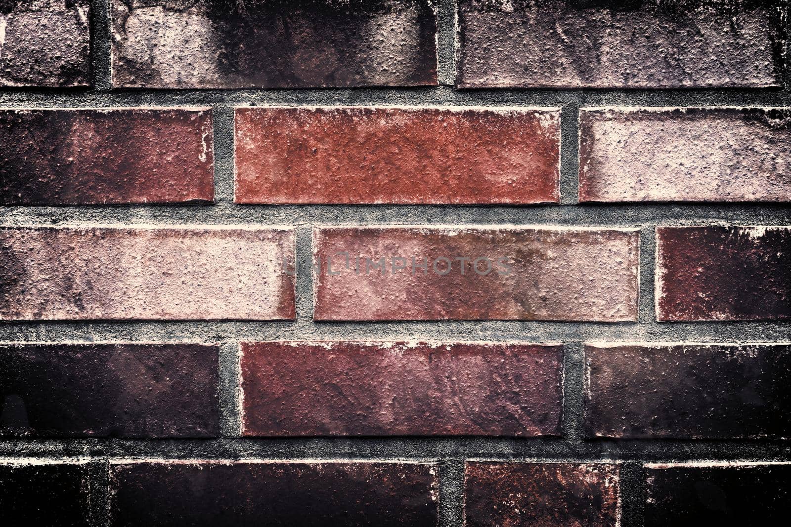 Aged and weathered old brick wall texture in a retro vintage design  by MP_foto71