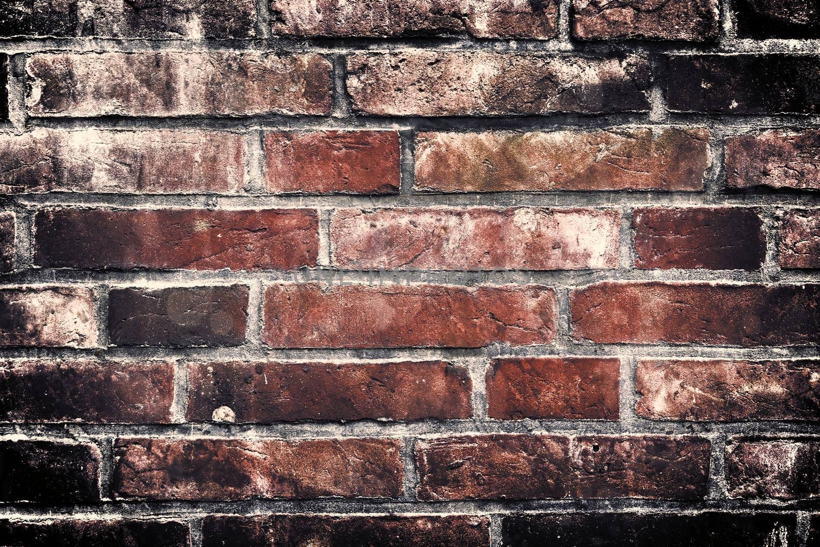 Aged and weathered old brick wall texture in a retro vintage design  by MP_foto71