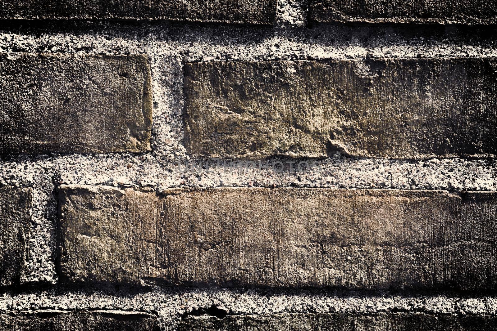 Aged and weathered old brick wall texture in a retro vintage design  by MP_foto71