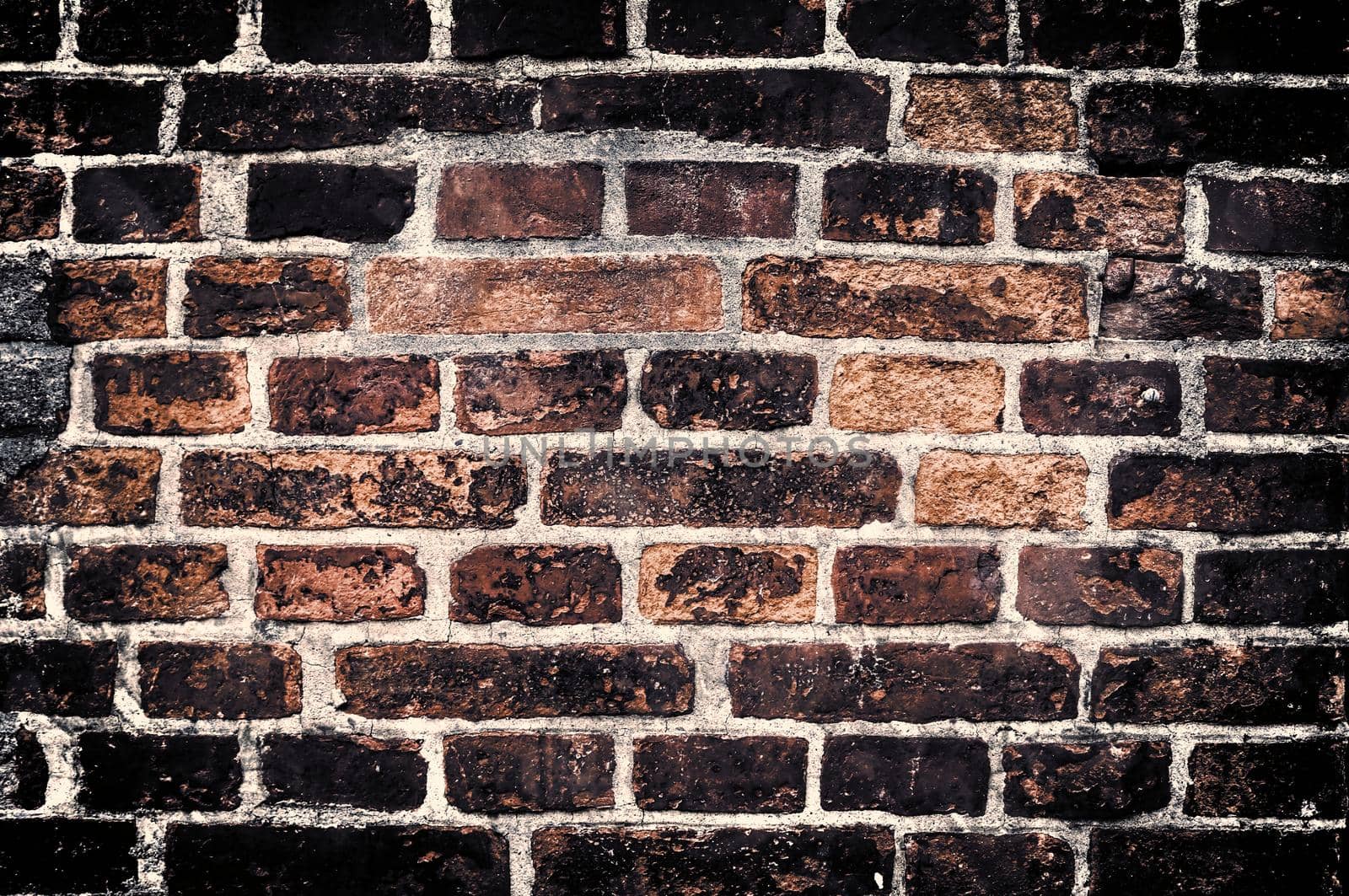 Aged and weathered old brick wall texture in a retro vintage design  by MP_foto71