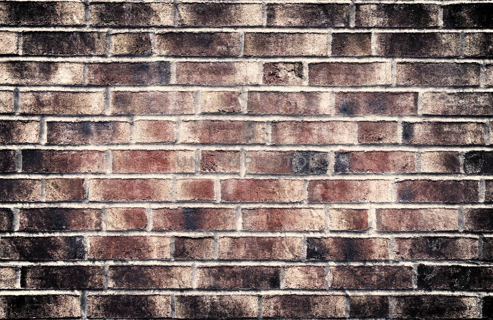 Aged and weathered old brick wall texture in a retro vintage design  by MP_foto71