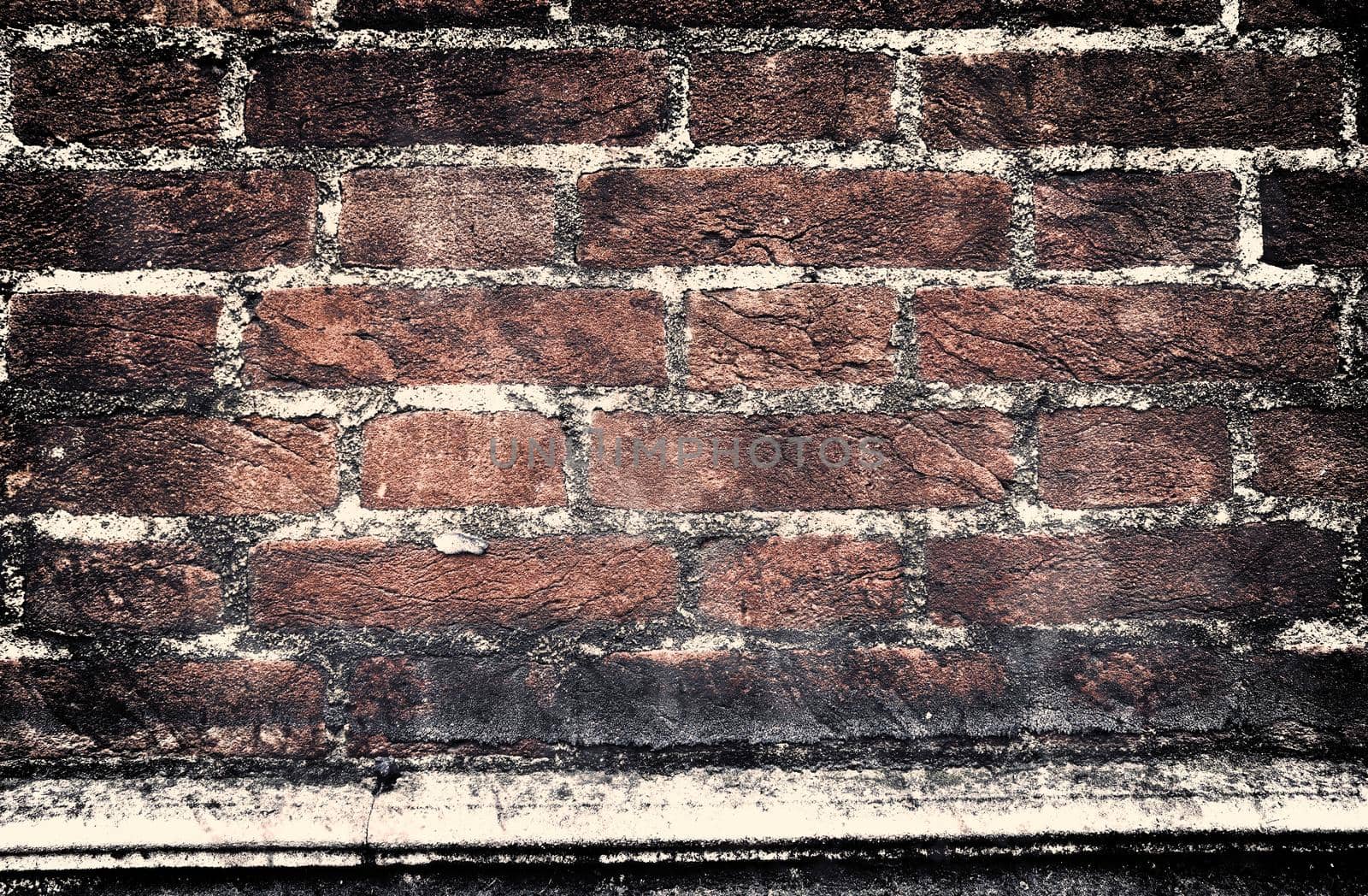 Aged and weathered old brick wall texture in a retro vintage design  by MP_foto71