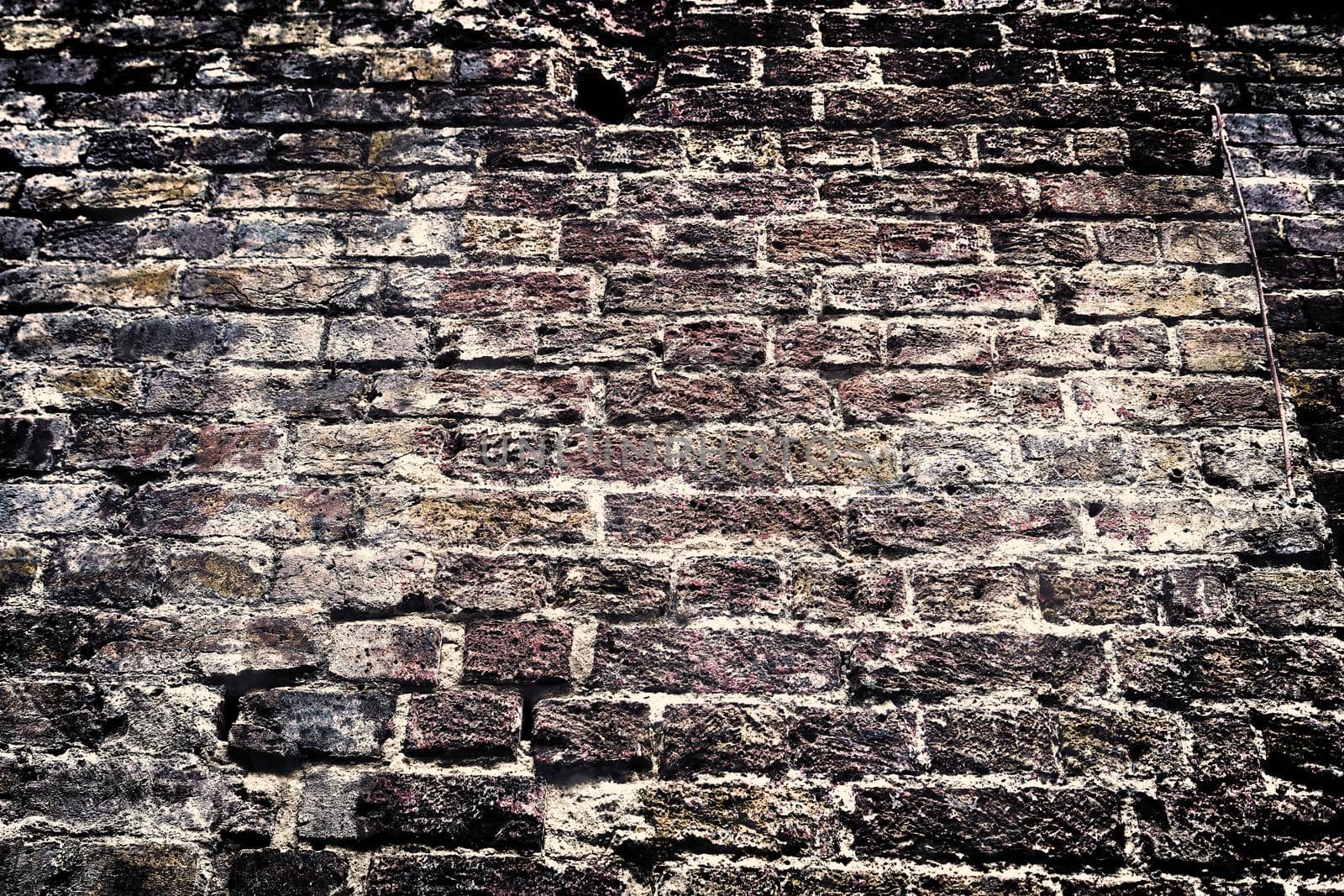 Aged and weathered old brick wall texture in a retro vintage design  by MP_foto71