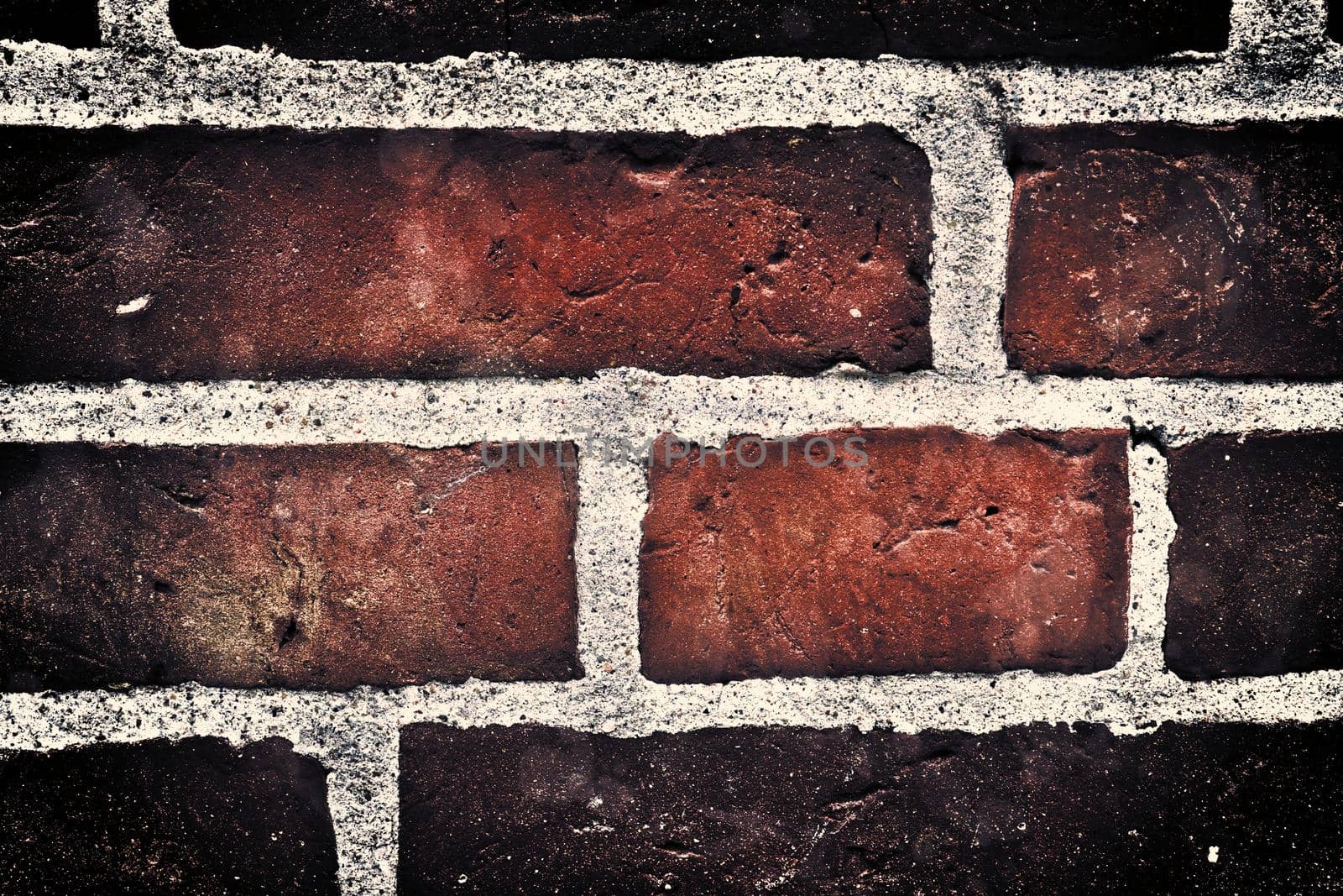 Aged and weathered old brick wall texture in a retro vintage design  by MP_foto71