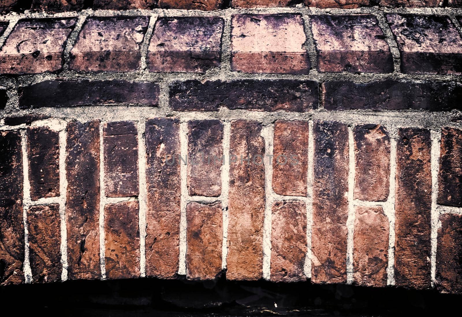 Aged and weathered old brick wall texture in a retro vintage design  by MP_foto71