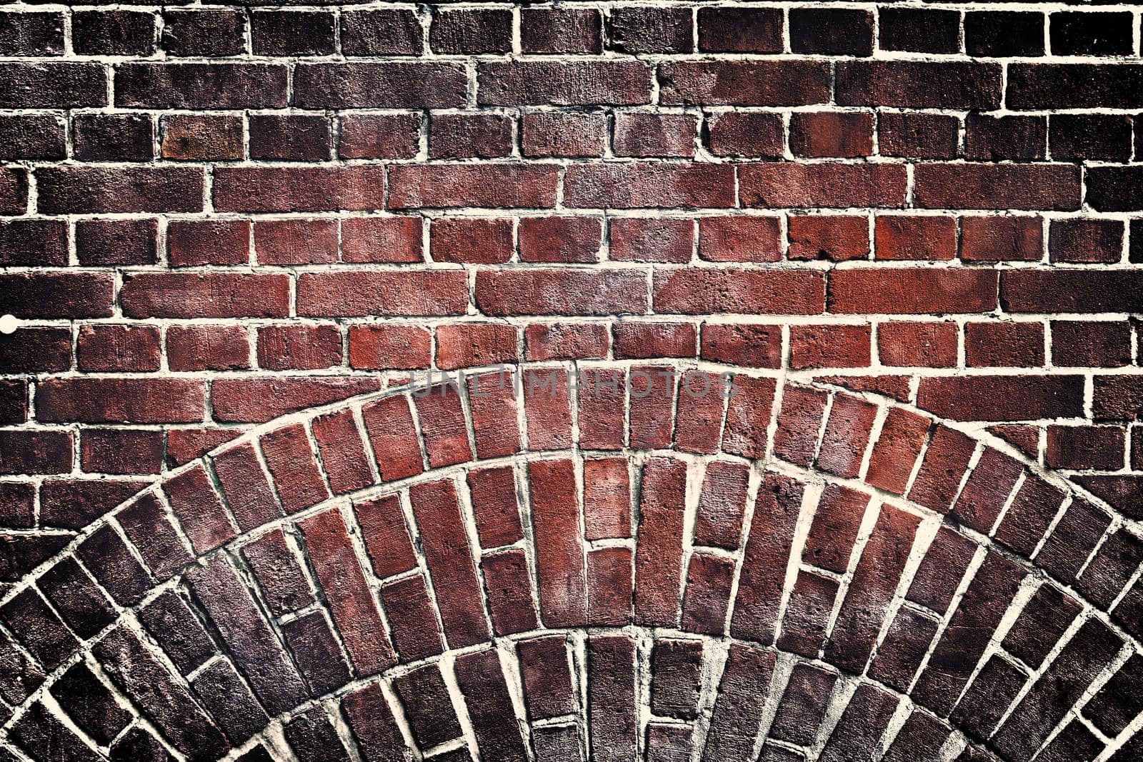 Aged and weathered old brick wall texture in a retro vintage design  by MP_foto71