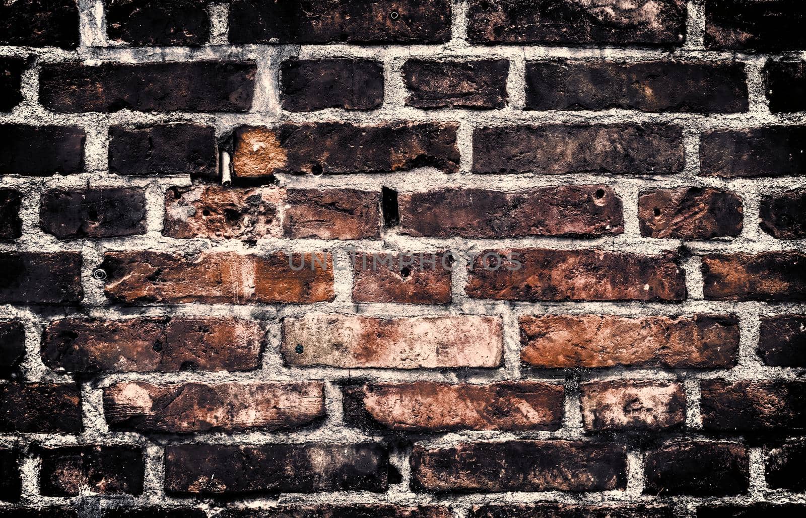 Aged and weathered old brick wall texture in a retro vintage design  by MP_foto71