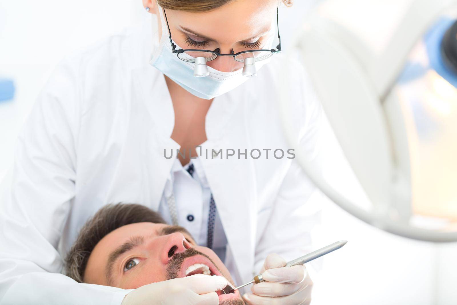 Patient with female Dentist - dental treatment by Kzenon