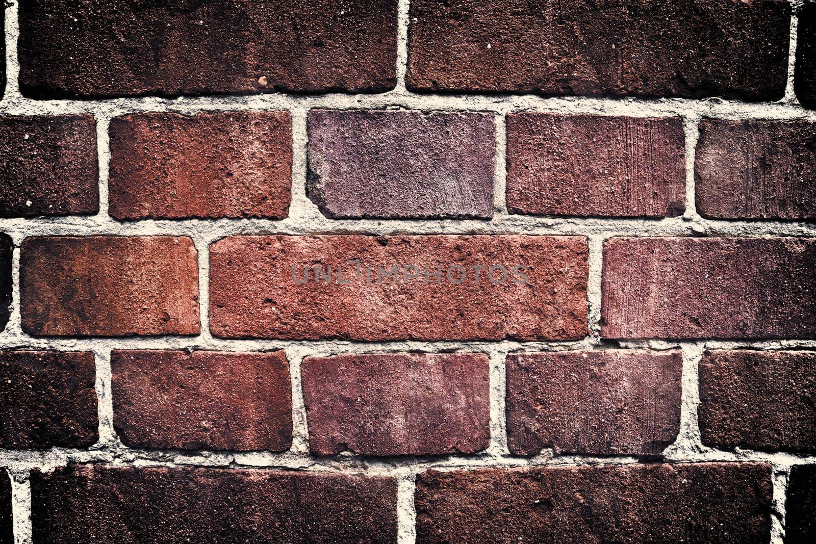 Aged and weathered old brick wall texture in a retro vintage design  by MP_foto71