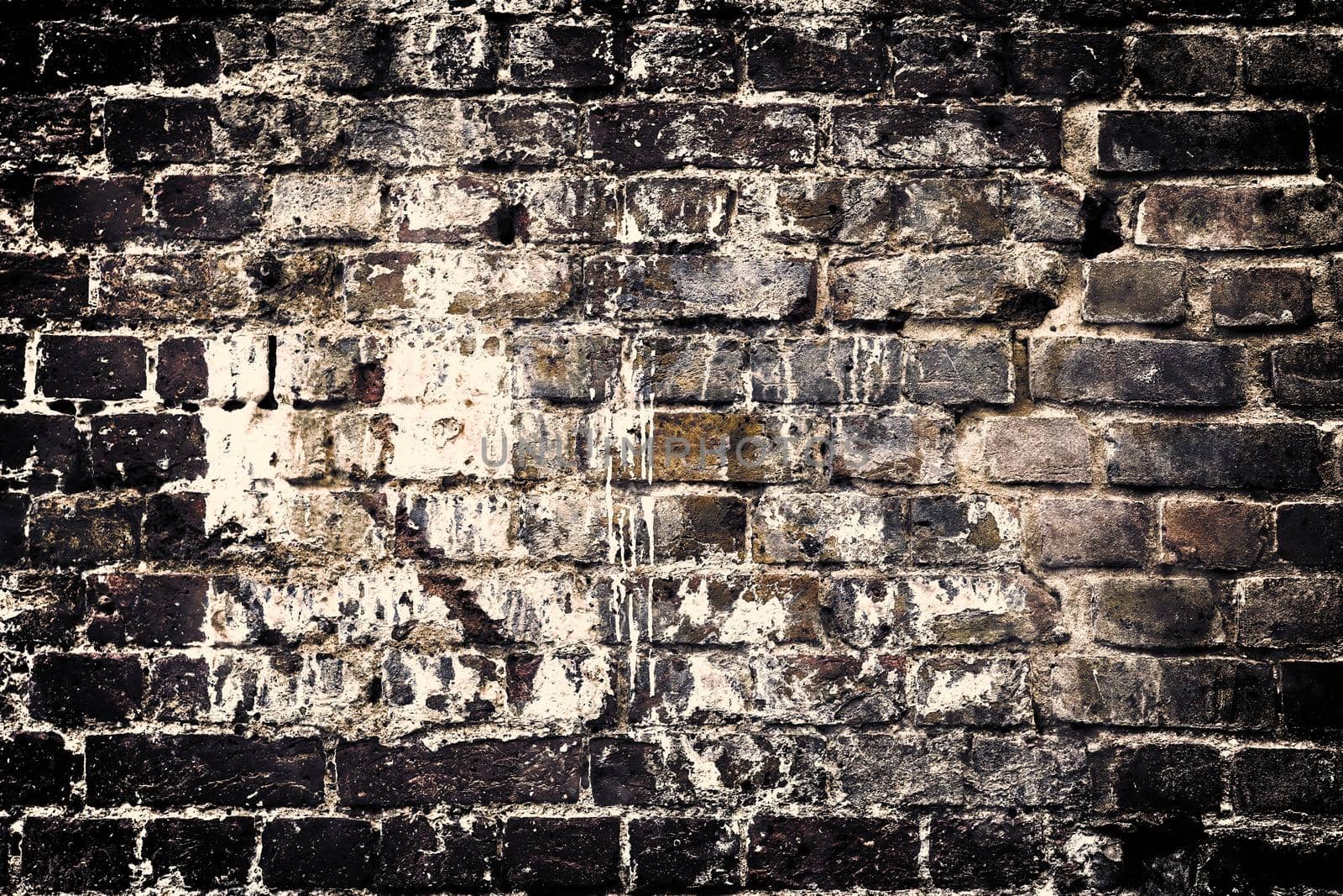 Aged and weathered old brick wall texture in a retro vintage design  by MP_foto71