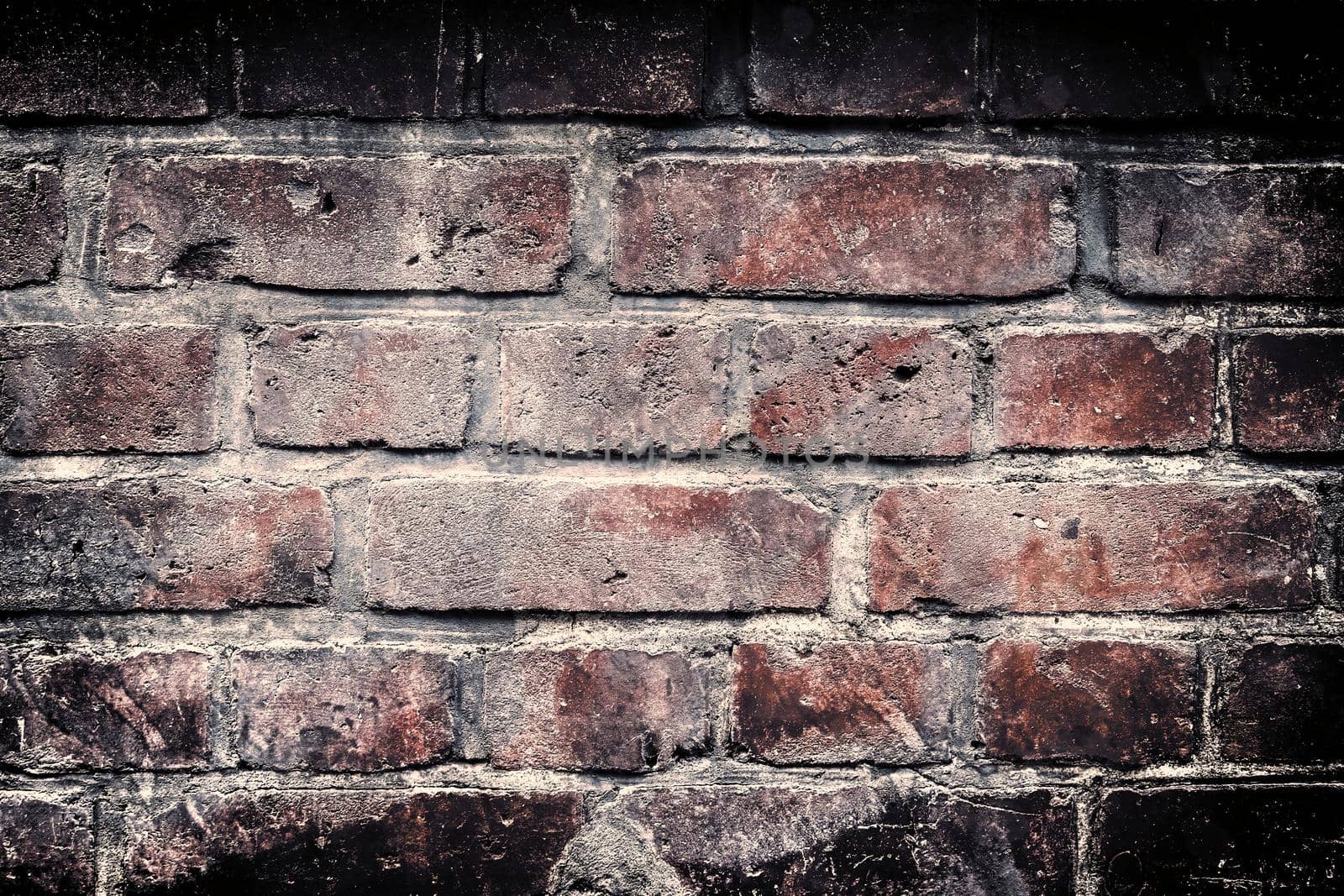 Aged and weathered old brick wall texture in a retro vintage design  by MP_foto71