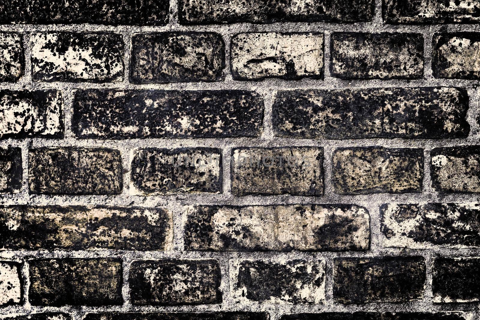 Aged and weathered old brick wall texture in a retro vintage design  by MP_foto71