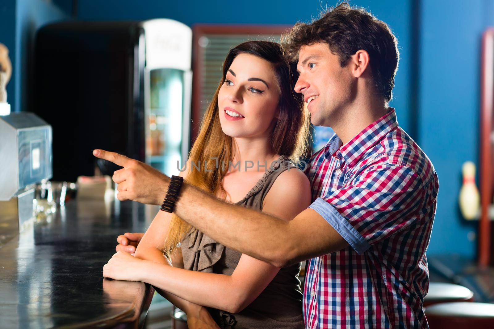 Young people or couple having a date in a club or a bar