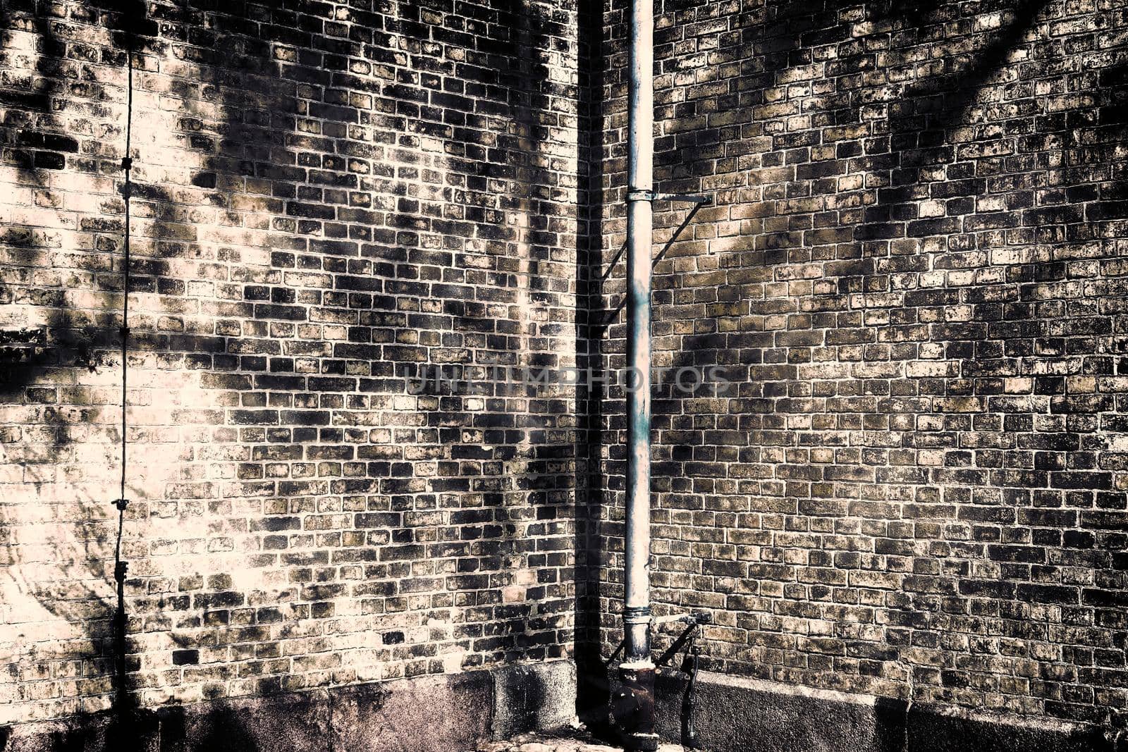 Aged and weathered old brick wall texture in a retro vintage design  by MP_foto71