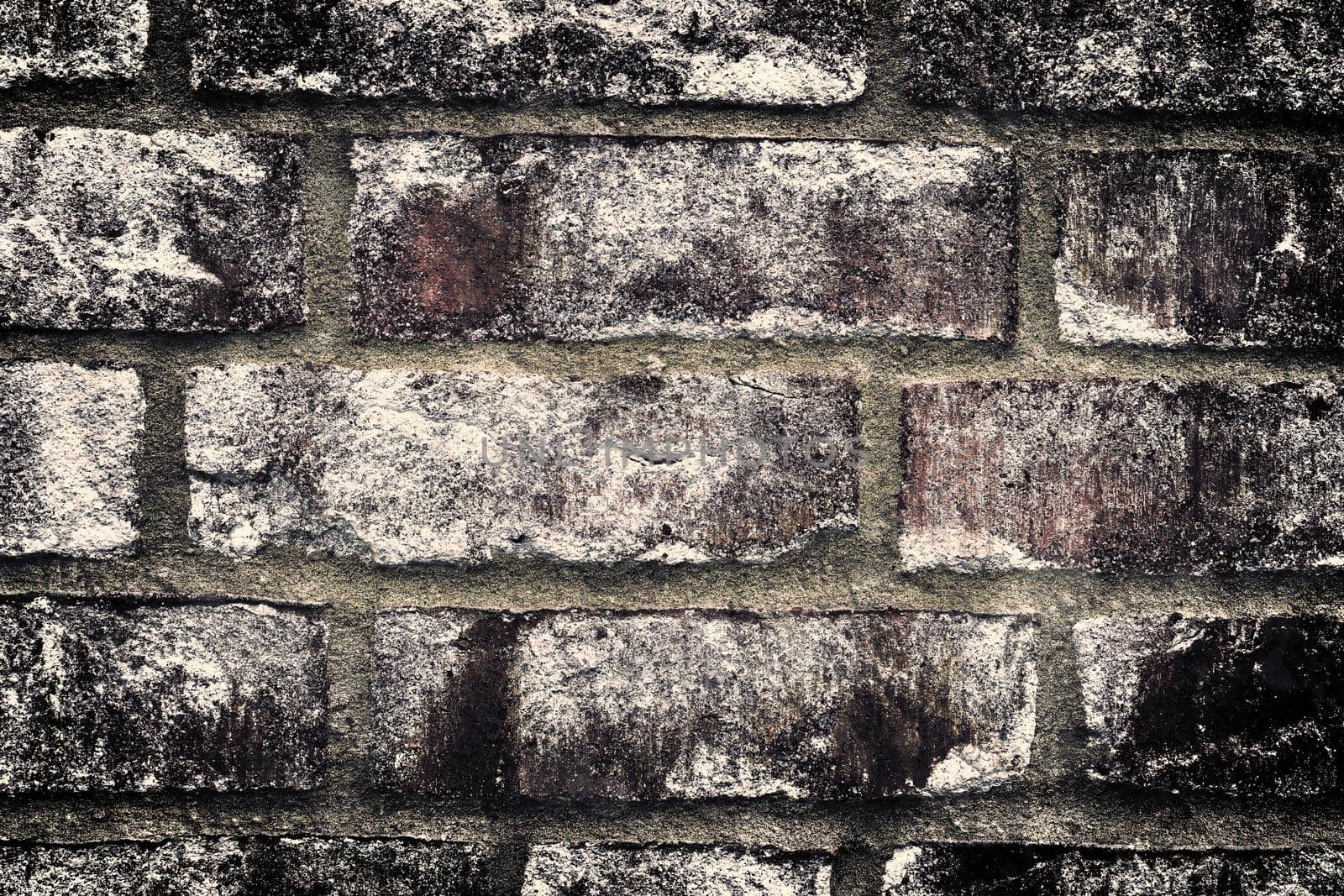 Aged and weathered old brick wall texture in a retro vintage design  by MP_foto71