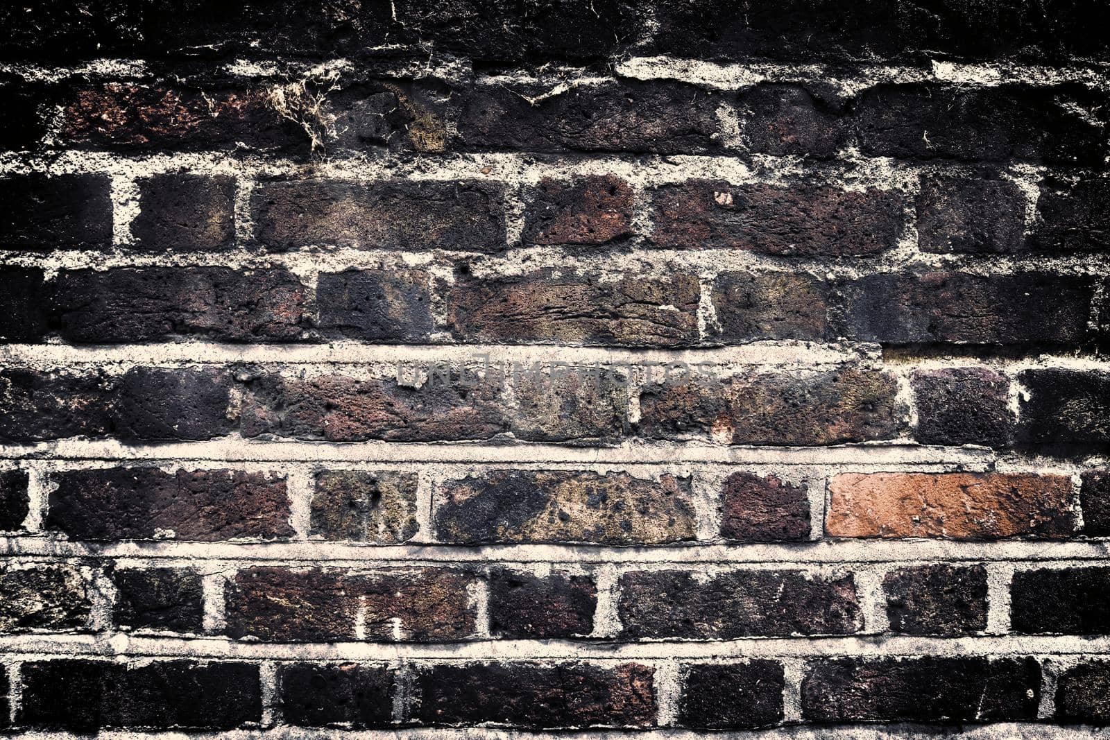 Aged and weathered old brick wall texture in a retro vintage design  by MP_foto71