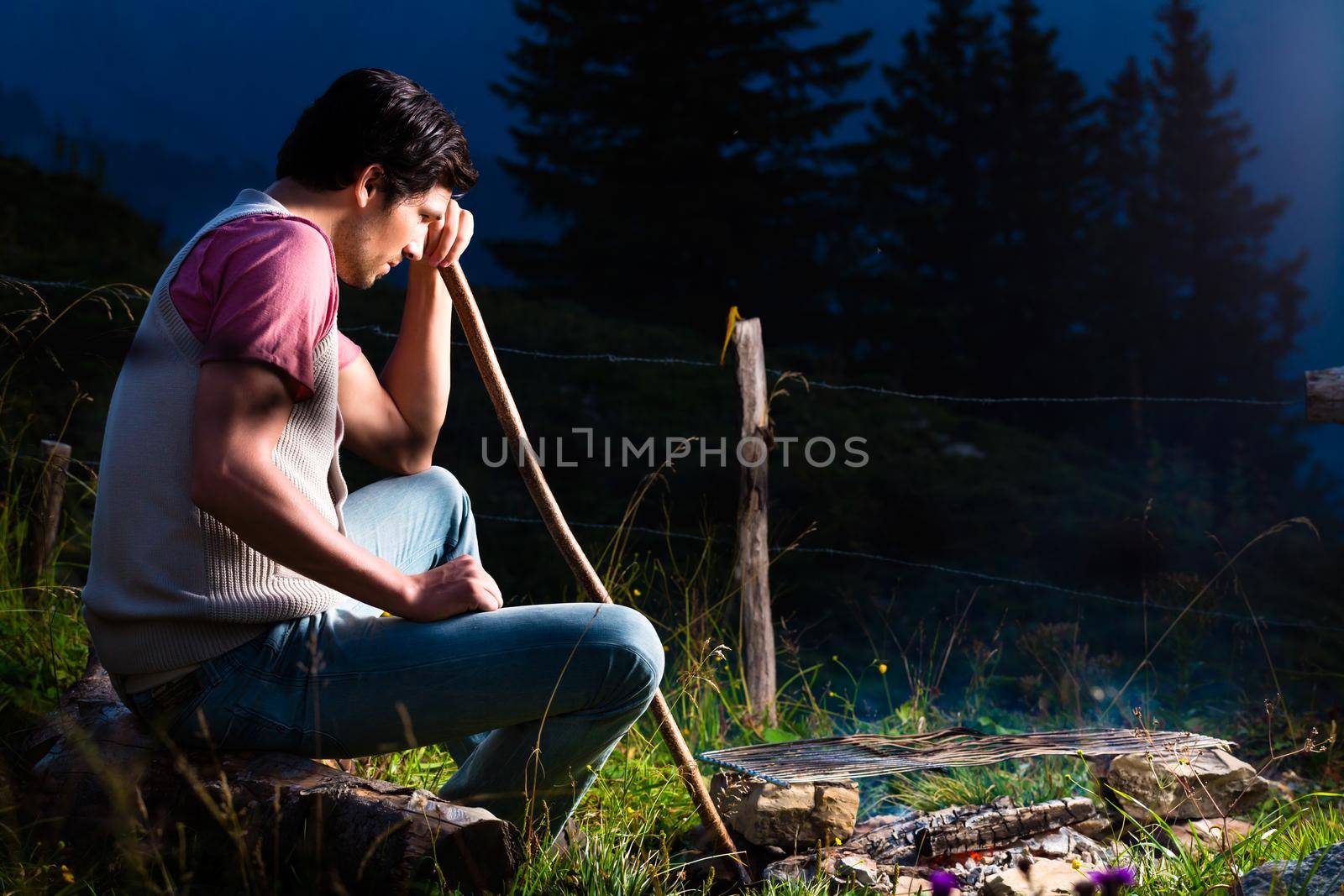 Alps - Man at campfire in Bavarian mountains by Kzenon