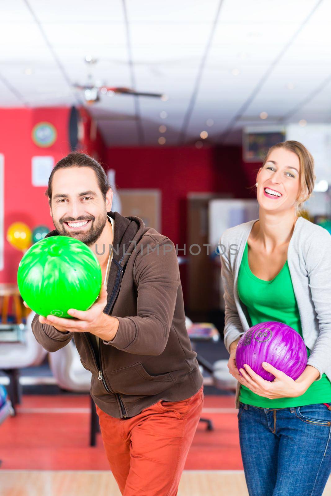 Happy couple playing Bowling together