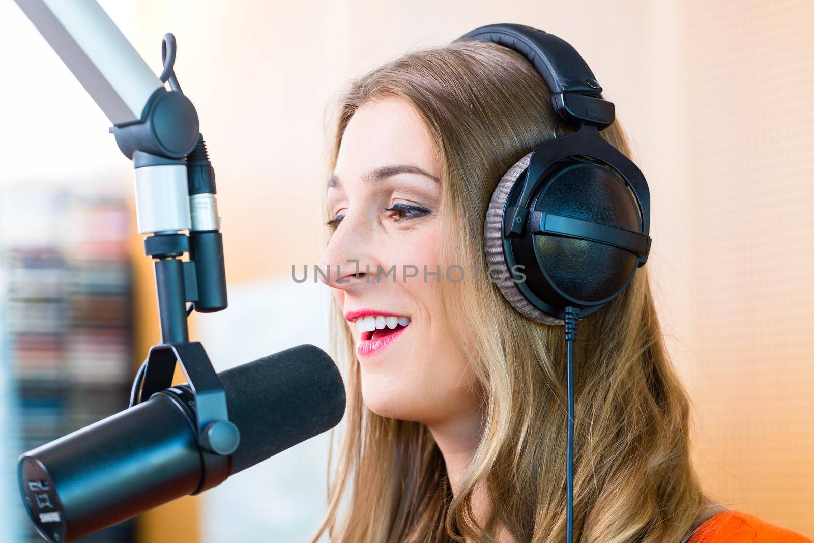 Female radio presenter in radio station on air by Kzenon